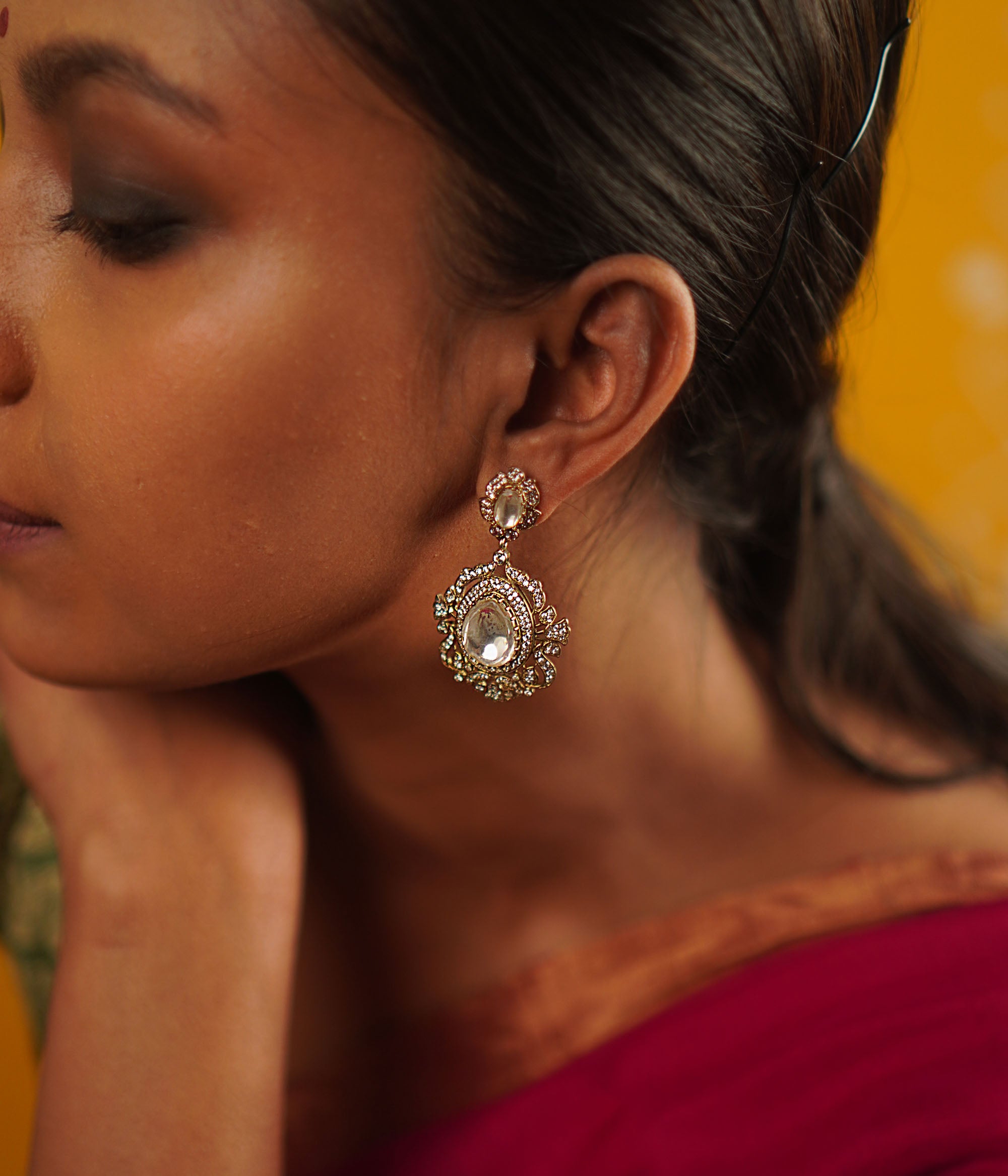 A timeless mini heirloom, these gold-plated silver drop earrings feature radiant Polki and CZ stones, blending classic craftsmanship with modern elegance.