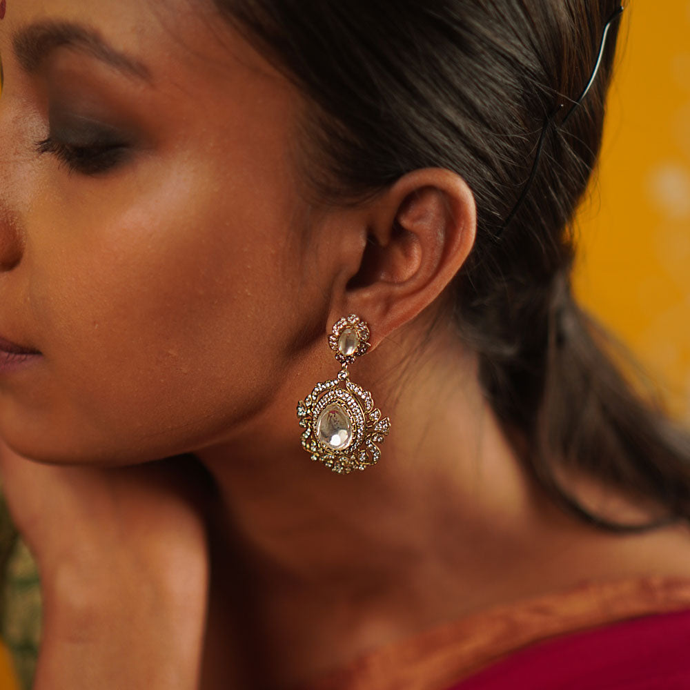 A timeless mini heirloom, these gold-plated silver drop earrings feature radiant Polki and CZ stones, blending classic craftsmanship with modern elegance.