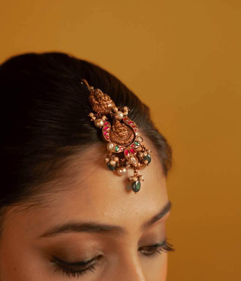 Elegant temple-inspired maangtika from DivasMantra with vibrant gemstones