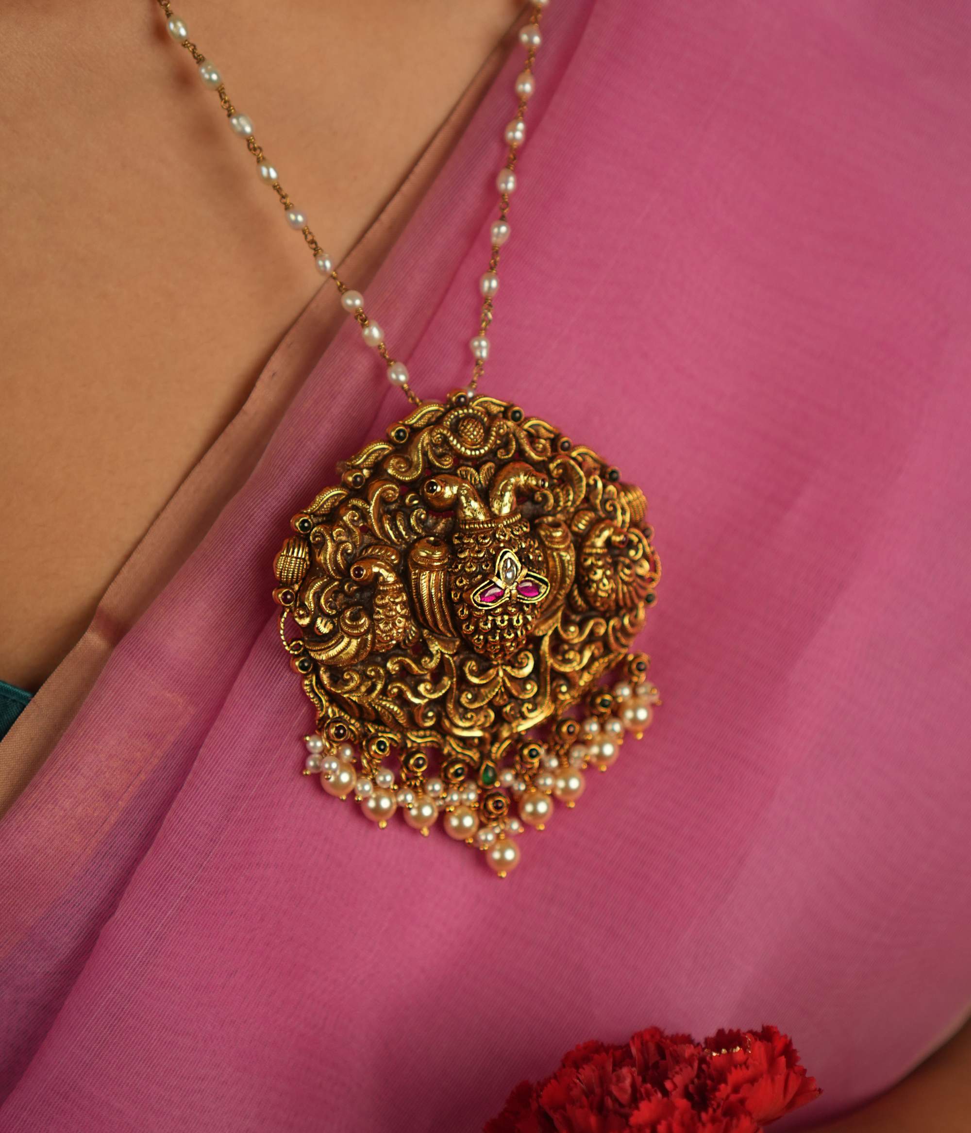 Adorn yourself with timeless elegance through our exquisite handcrafted pendant, featuring red and white Kundan stones, along with red and green spinel stones. Perfectly designed for traditional occasions, this pendant adds a touch of grace and sophistication to your ensemble.