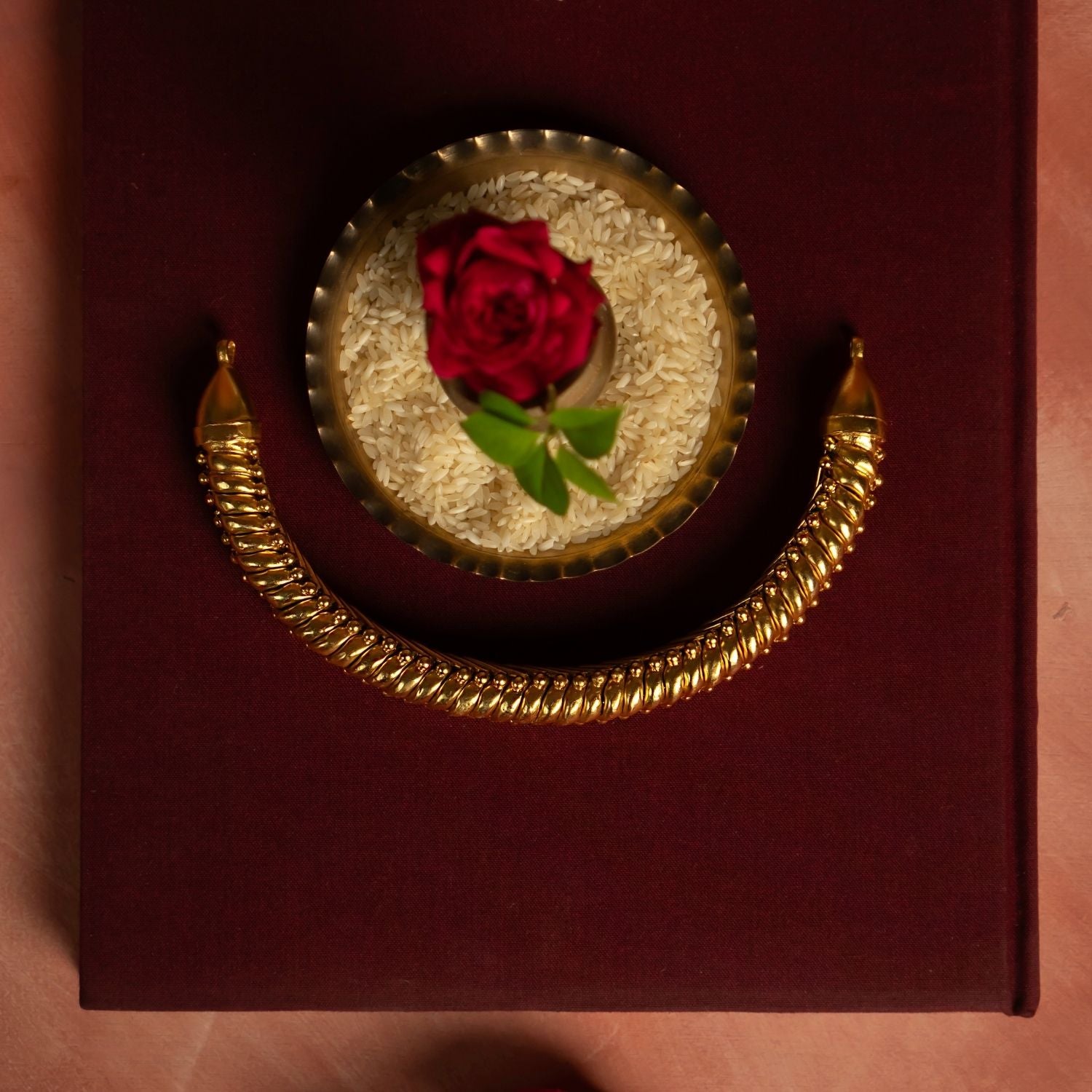 A beautifully crafted gold-plated silver jewellery piece, featuring a thick spiral-shaped chain that exudes elegance and tradition. This intricately designed chain is adorned with delicate golden beads at the ends, adding a touch of sophistication and charm. Its timeless design makes it a perfect accessory for both traditional and contemporary ensembles.