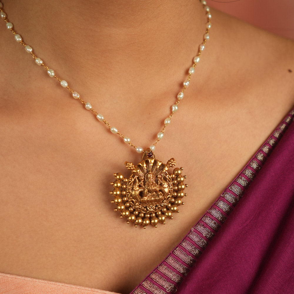 Divine whispers reborn! Gold-plated temple pendant with Goddess Lakshmi radiates faith and timeless devotion.