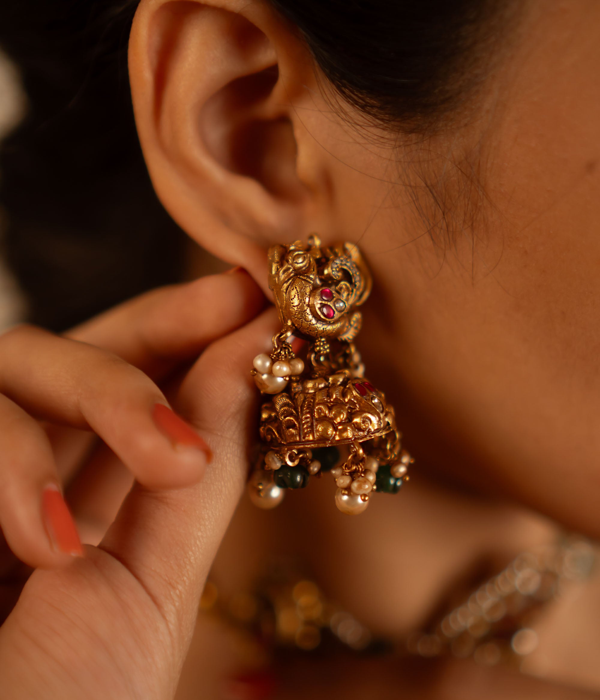 Red and white kundan stone jhumka earrings with screw fastening
