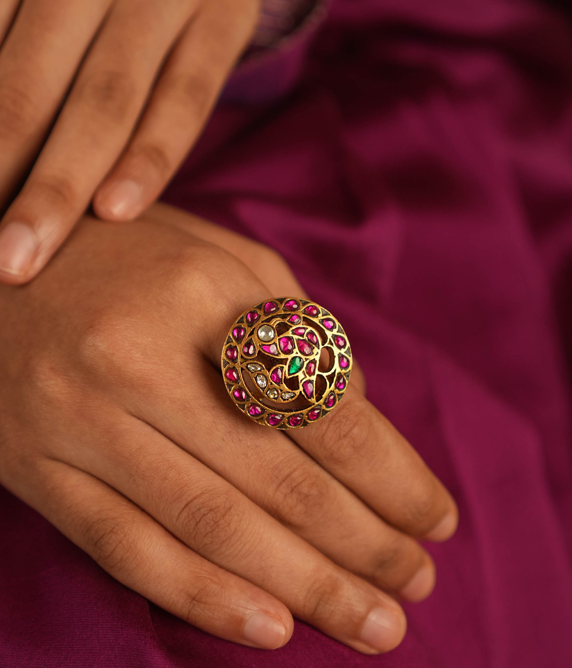 Majestic plumage reborn! This Kundan peacock ring dazzles with red, green, and white stones, echoing timeless grace and regal charm.