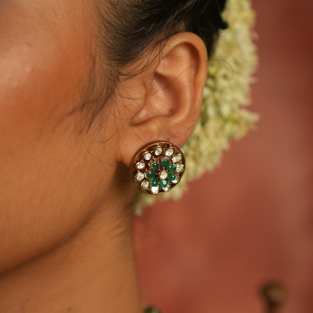 Apsara earrings with Polki stones and green gemstones.