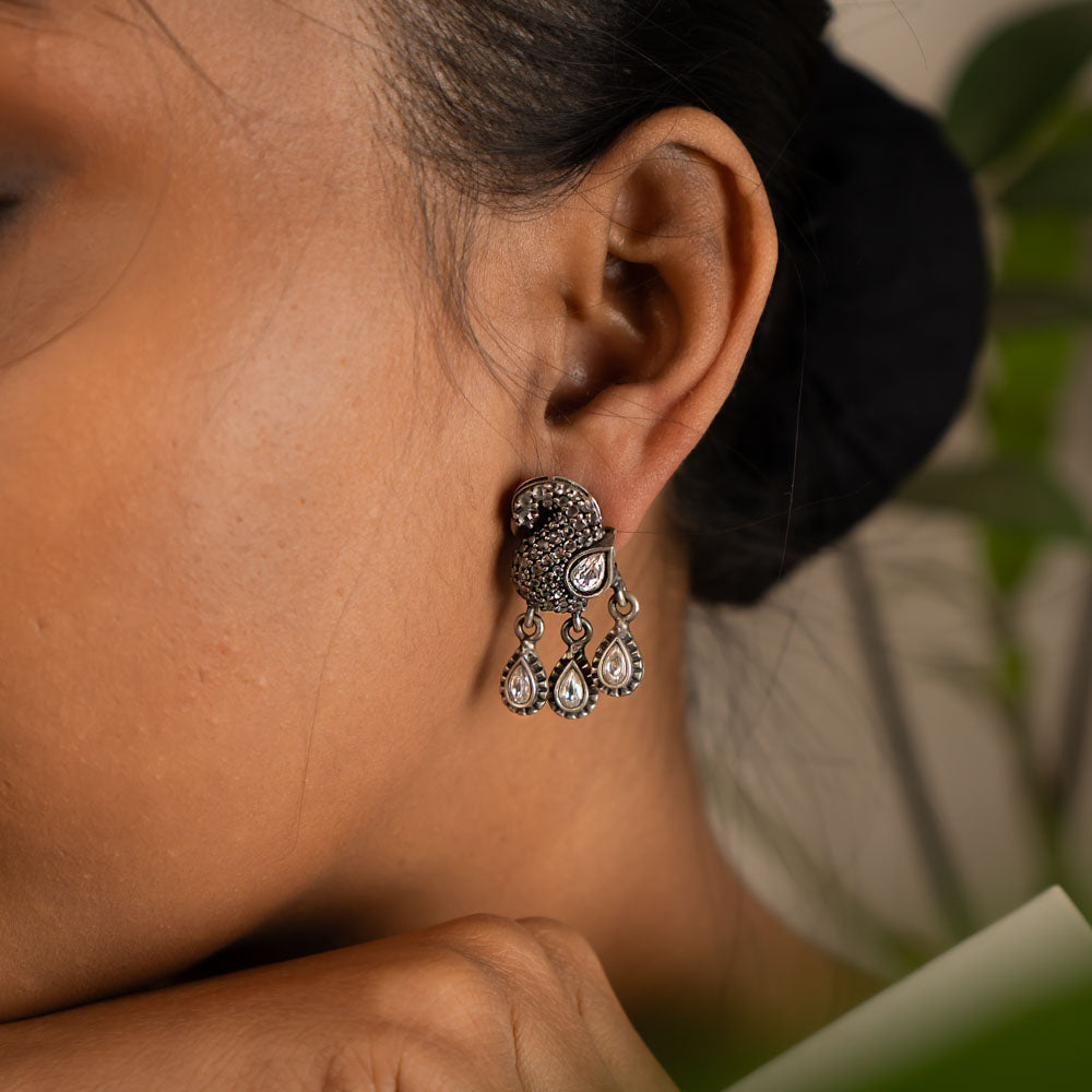 These handcrafted drop earrings, inspired by the sacred geometry of the balsam flower, exude a timeless charm with a touch of spiritual elegance.