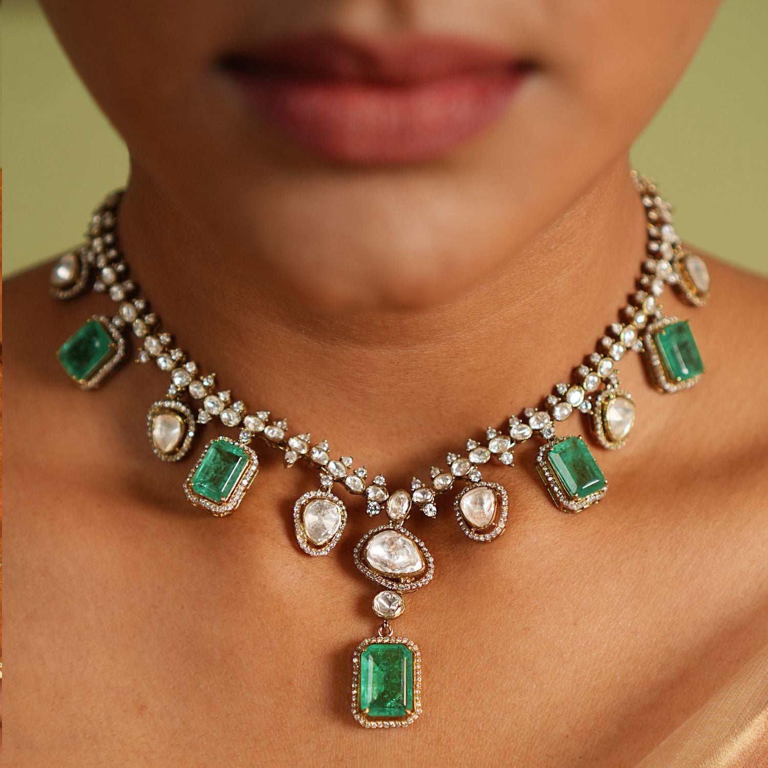 Elegant short necklace crafted in gold-plated silver, adorned with drops dazzling CZ stones, vibrant green gemstones, exquisite Polki stones creating a timeless and sophisticated design perfect for any occasion.