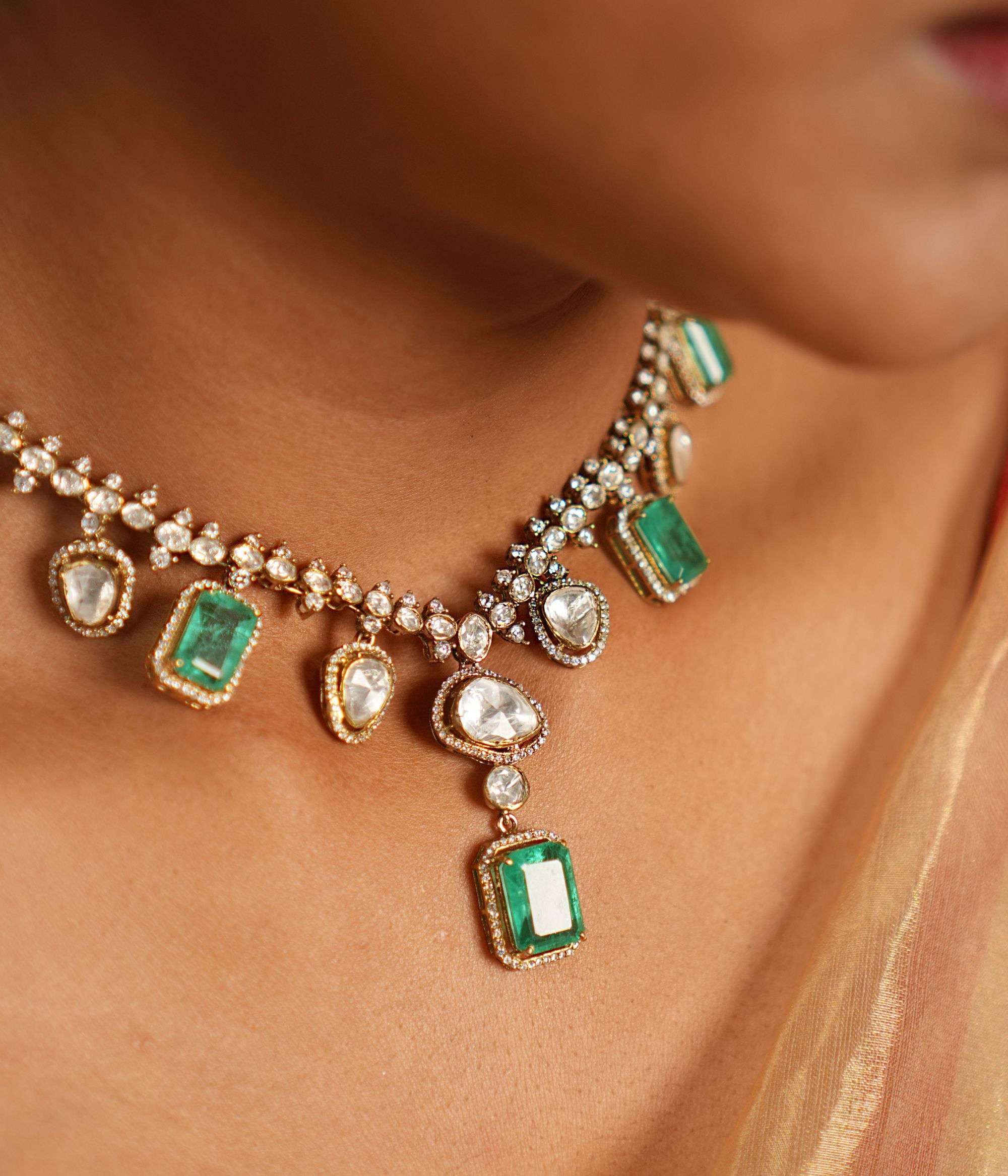 Elegant short necklace crafted in gold-plated silver, adorned with drops dazzling CZ stones, vibrant green gemstones, exquisite Polki stones creating a timeless and sophisticated design perfect for any occasion.