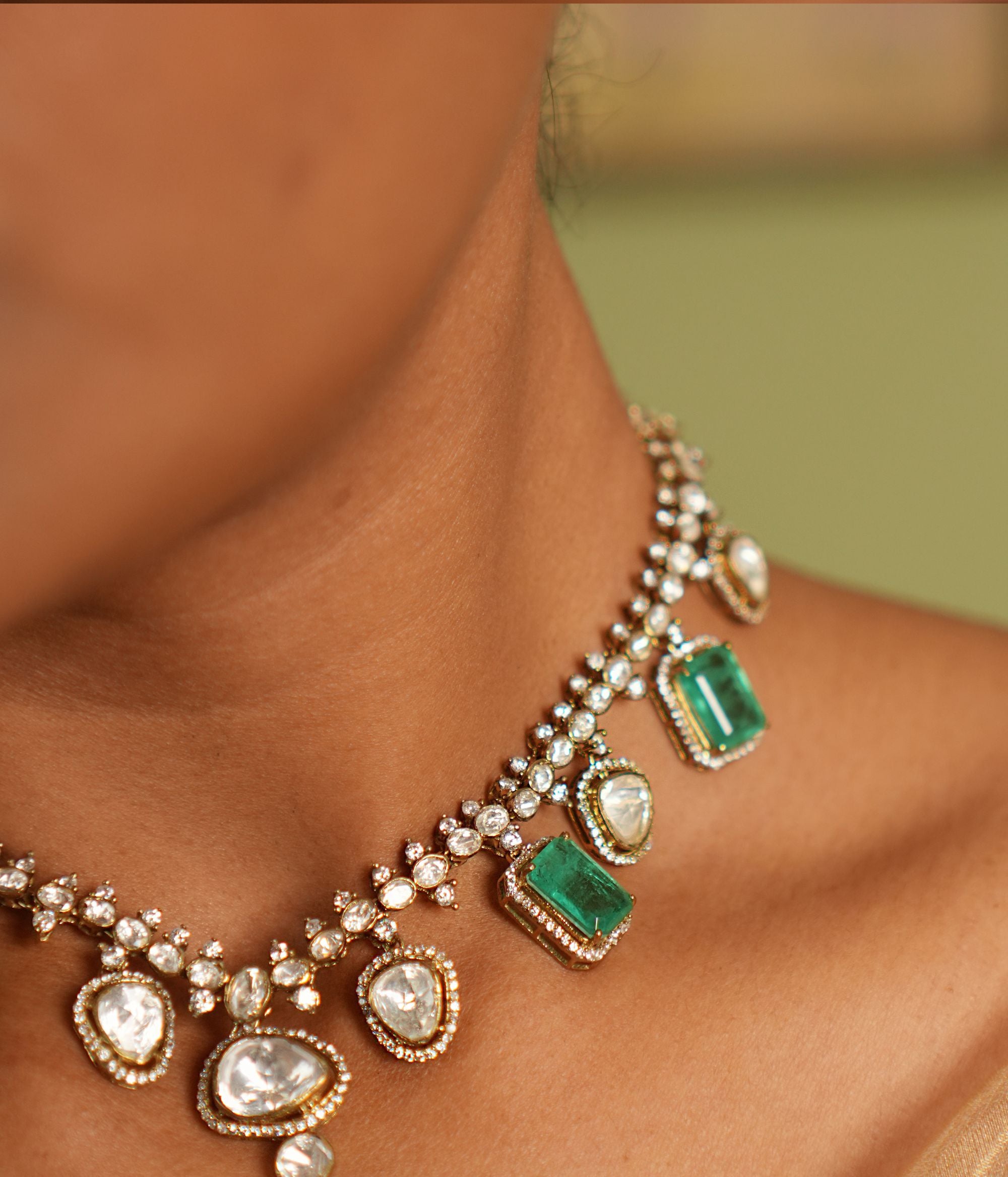 Elegant short necklace crafted in gold-plated silver, adorned with drops dazzling CZ stones, vibrant green gemstones, exquisite Polki stones creating a timeless and sophisticated design perfect for any occasion.