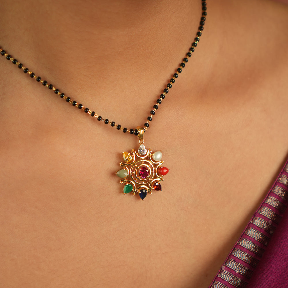 Celestial bloom reborn in a round Navratna pendant, where vibrant gems whisper ancient wisdom with modern elegance.