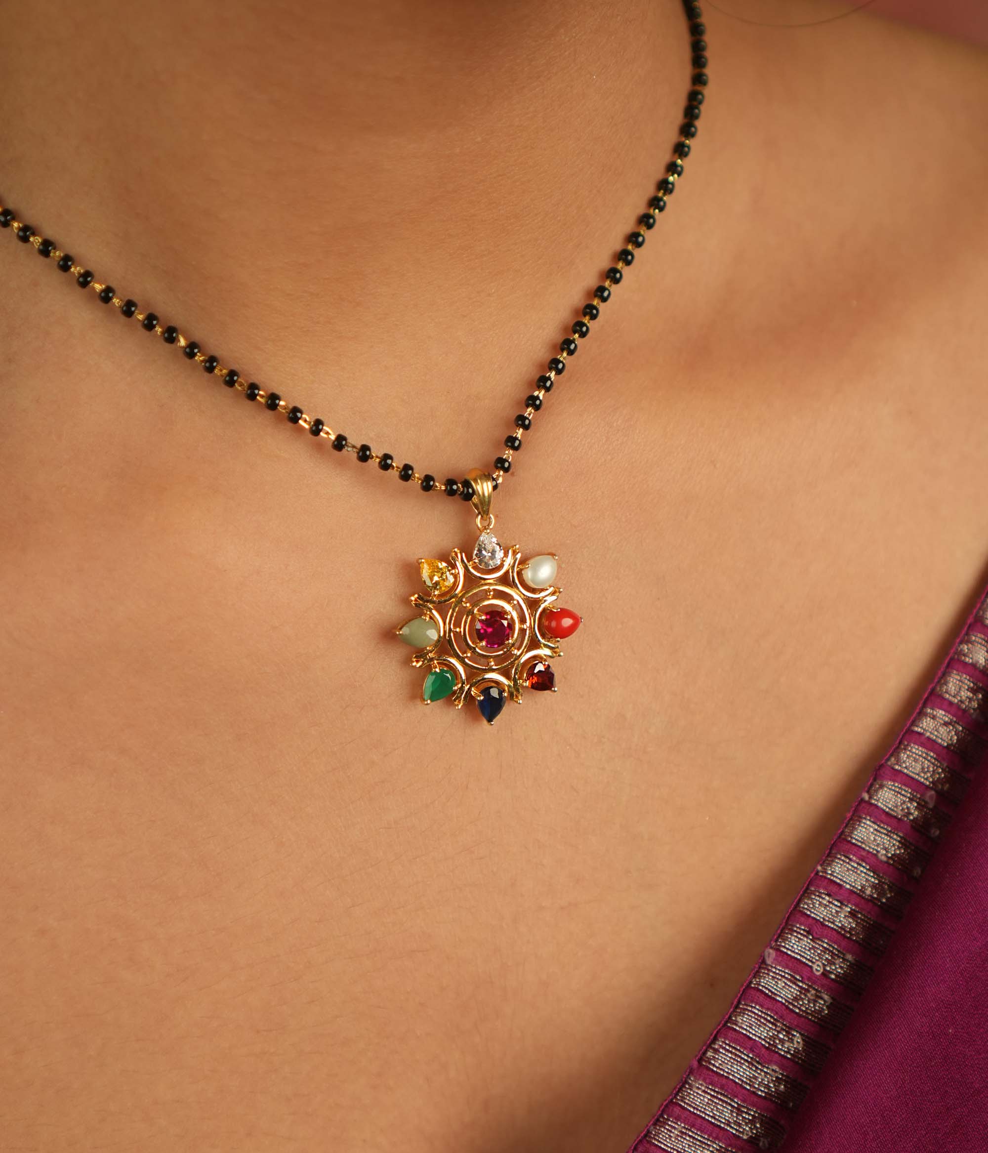 Celestial bloom reborn in a round Navratna pendant, where vibrant gems whisper ancient wisdom with modern elegance.