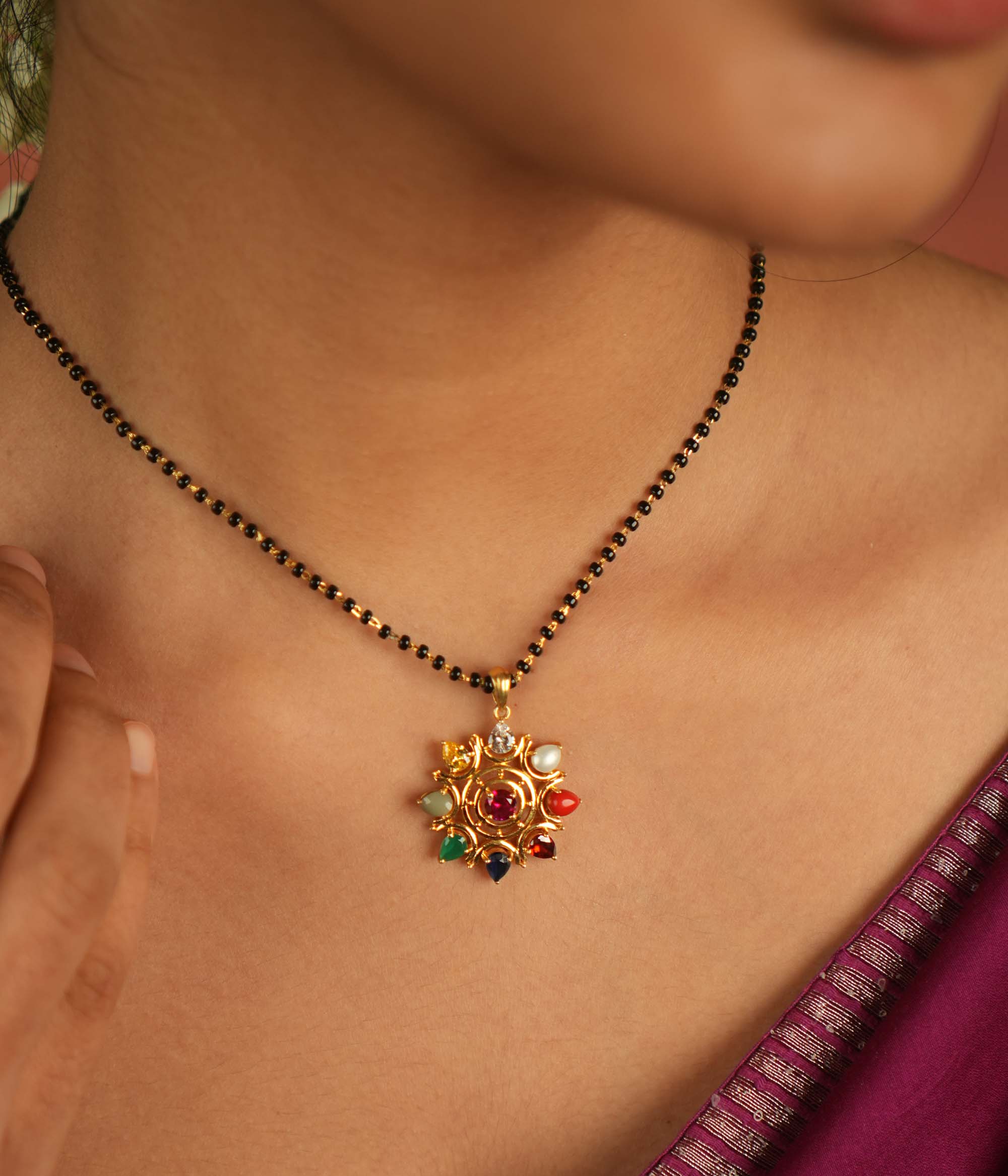 Celestial bloom reborn in a round Navratna pendant, where vibrant gems whisper ancient wisdom with modern elegance.