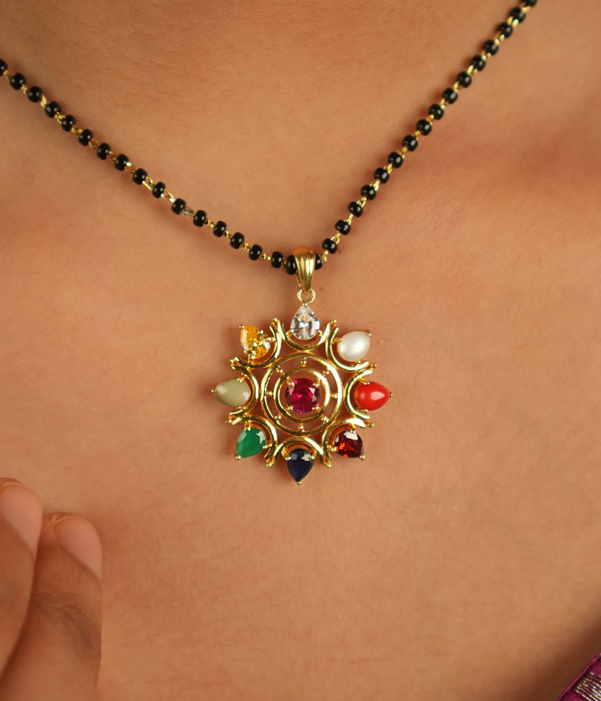 Celestial bloom reborn in a round Navratna pendant, where vibrant gems whisper ancient wisdom with modern elegance.