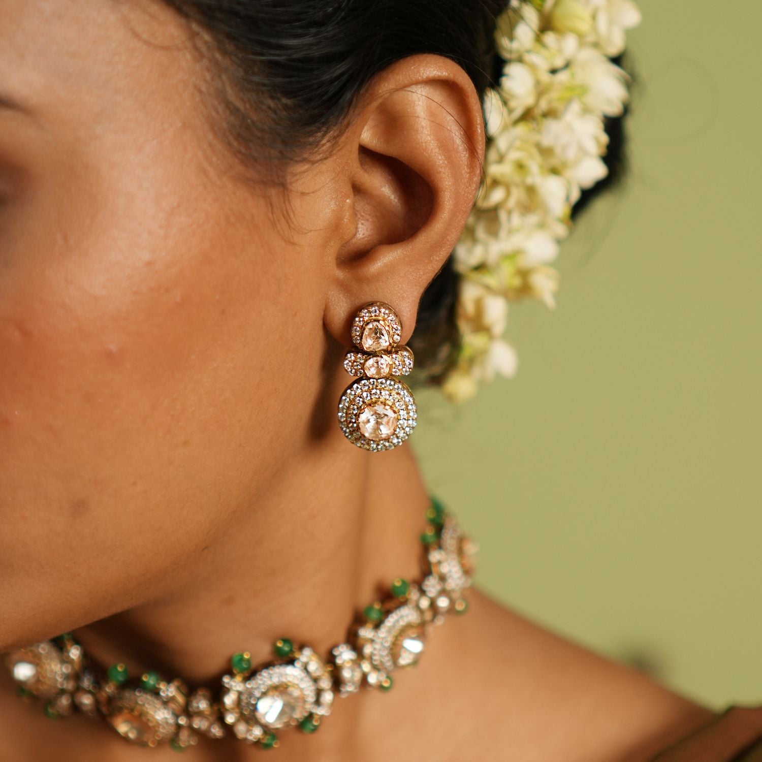 Elegant silver earrings with gold plating, adorned with sparkling Polki stones and shimmering cubic zirconia (CZ) stones. These earrings feature a timeless design, combining traditional craftsmanship with a modern touch, perfect for elevating any outfit.