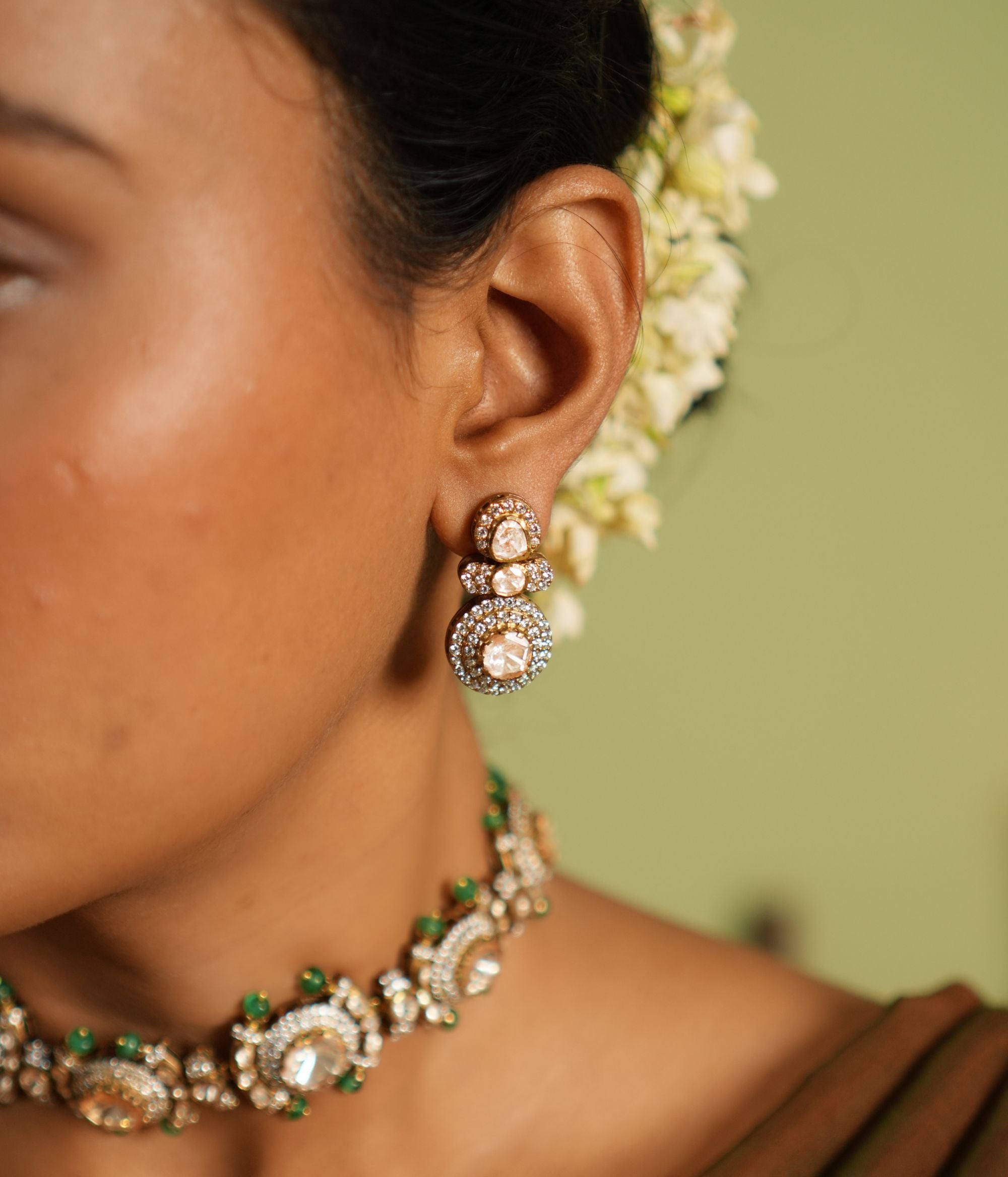 Elegant silver earrings with gold plating, adorned with sparkling Polki stones and shimmering cubic zirconia (CZ) stones. These earrings feature a timeless design, combining traditional craftsmanship with a modern touch, perfect for elevating any outfit.