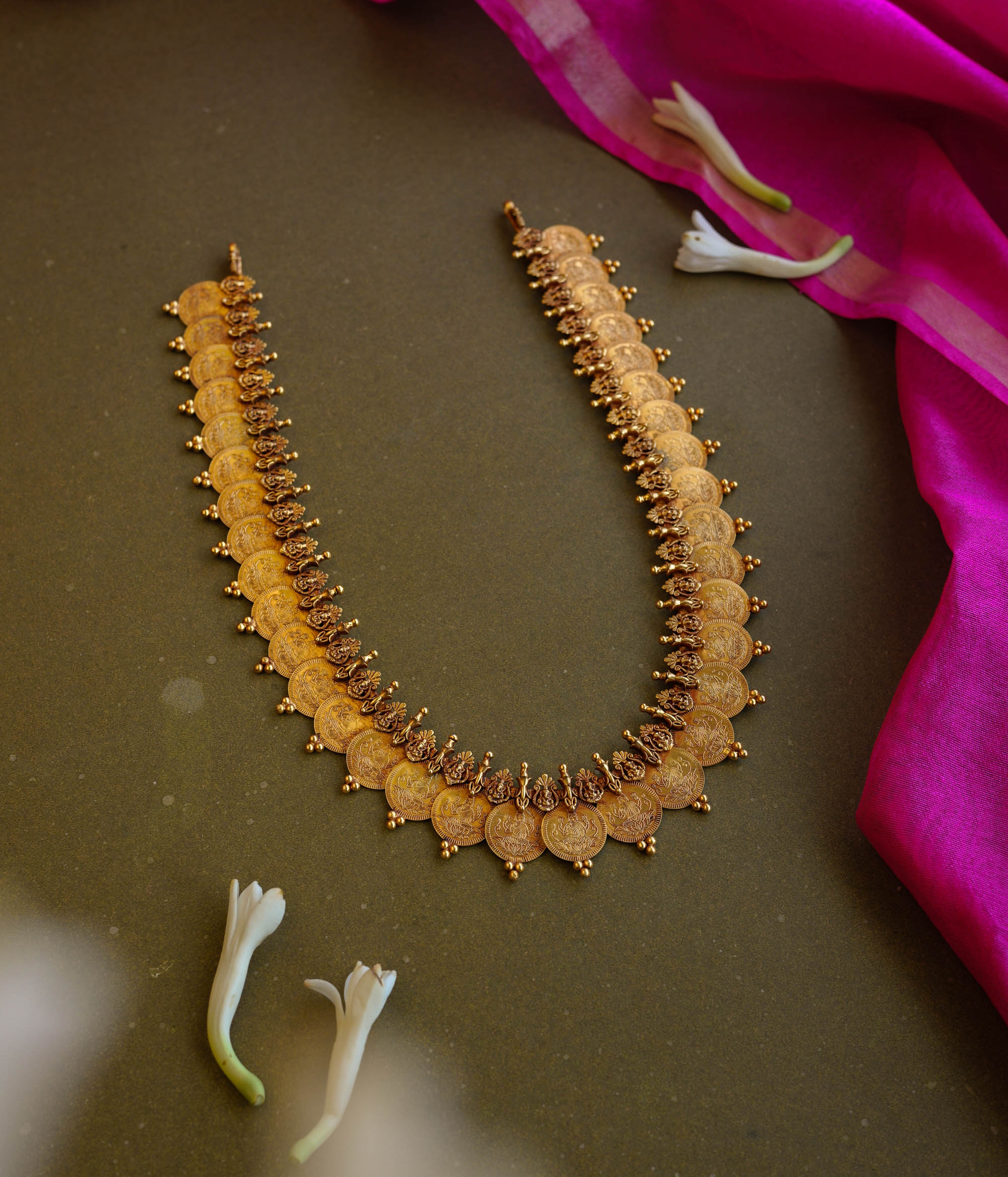Antique gold temple necklace with dual-layer goddess coin motifs and intricate bead detailing.