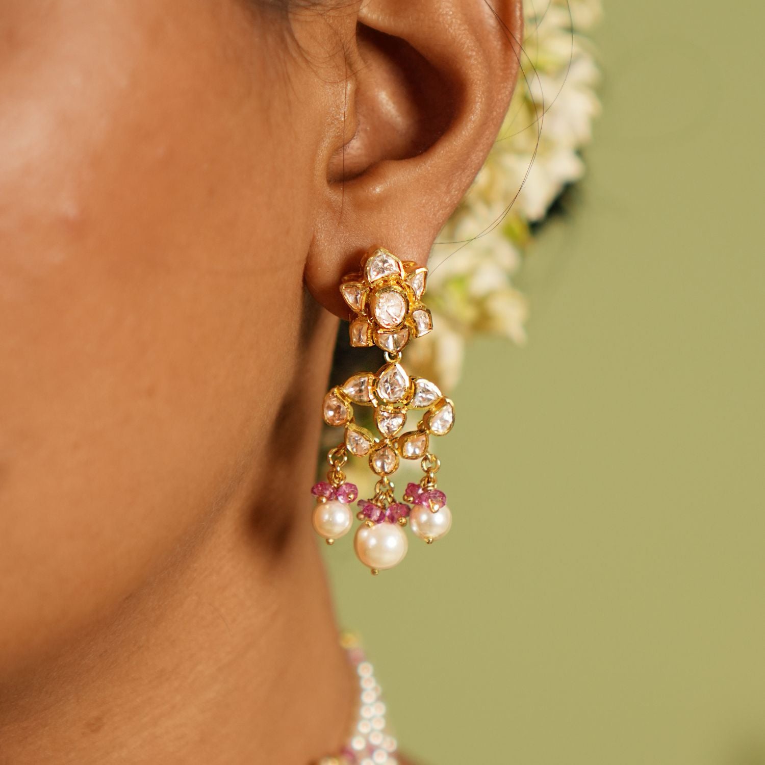 Elegant silver earrings with gold plating, adorned with shimmering Polki stones, white pearl drops, and delicate pink pearls, creating a sophisticated and feminine design perfect for any occasion.