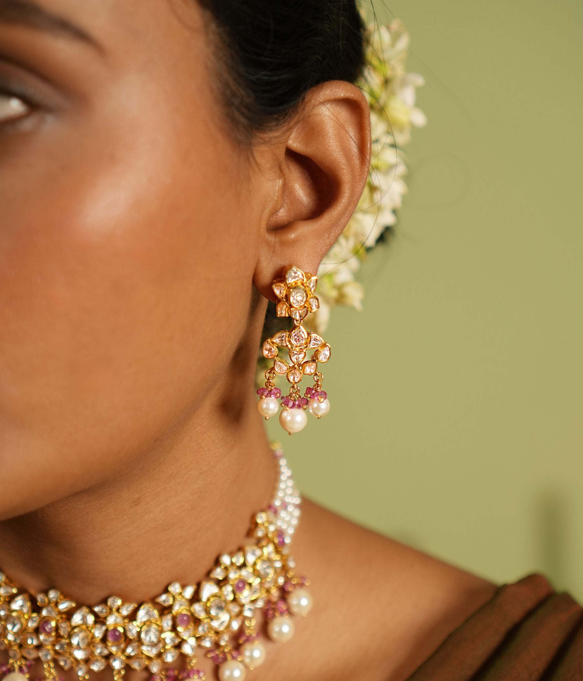 Elegant silver earrings with gold plating, adorned with shimmering Polki stones, white pearl drops, and delicate pink pearls, creating a sophisticated and feminine design perfect for any occasion.