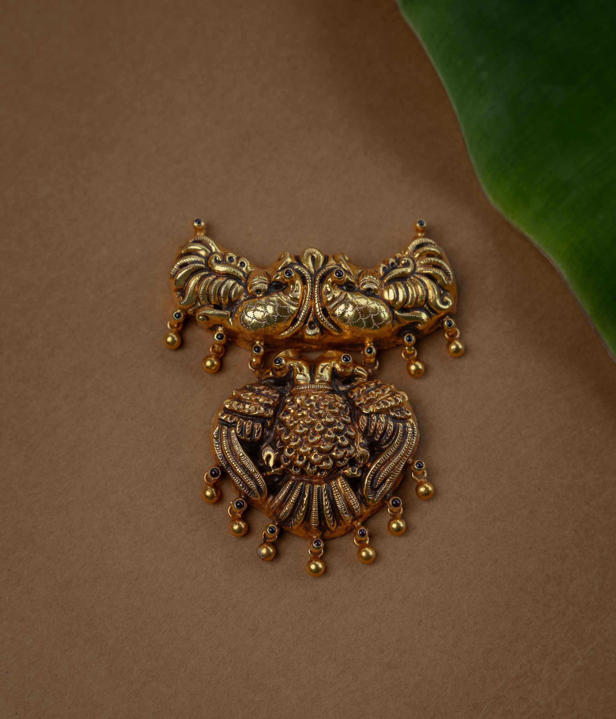 Temple Pendant with Red Spinal Stone, themed around Peacock.