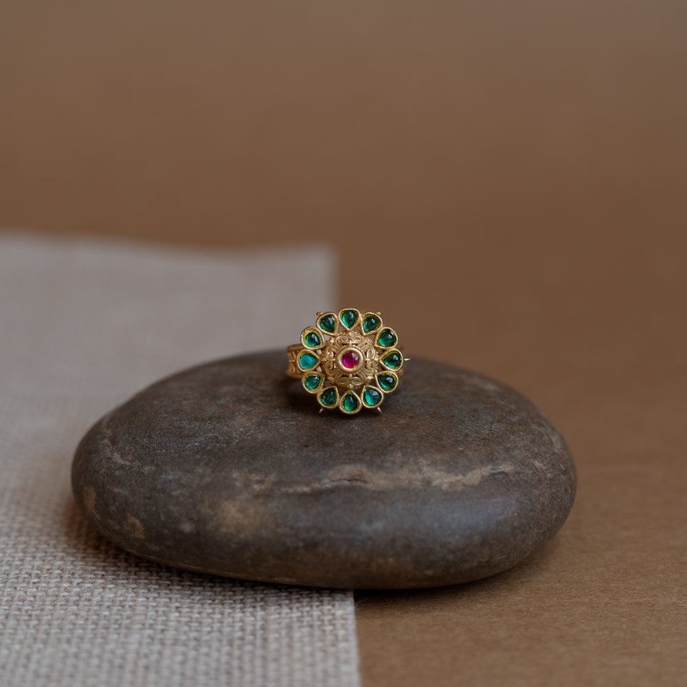 Temple collection ring with green Polki and red Spinal stones in traditional heritage design.