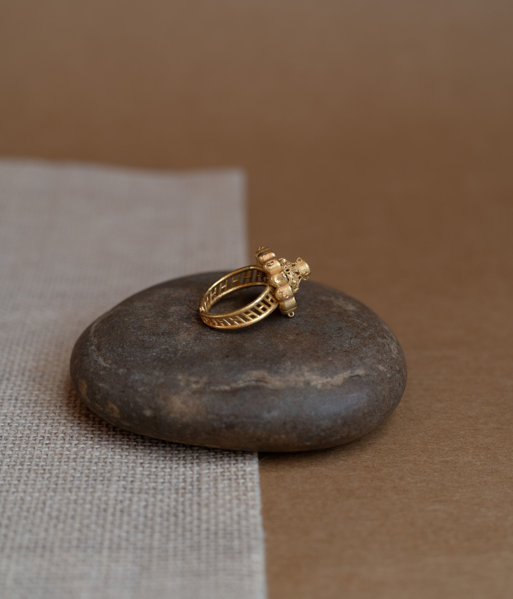 Temple collection ring with green Polki and red Spinal stones in traditional heritage design.