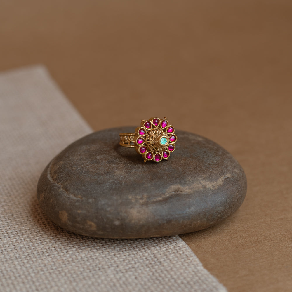 Temple ring with red Spinal and white Polki stones in traditional dual-tone design.