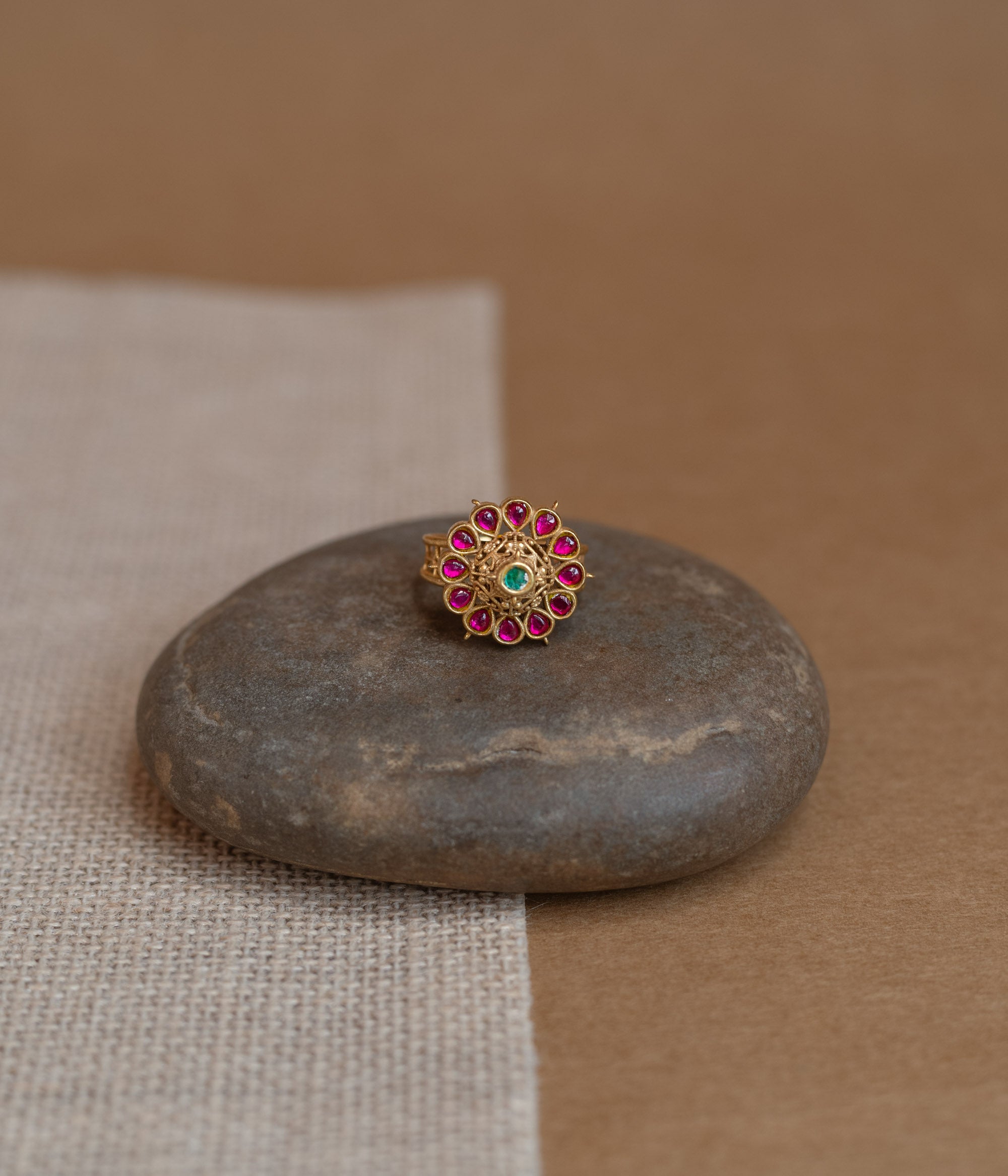 Temple ring with red Spinal and white Polki stones in traditional dual-tone design.