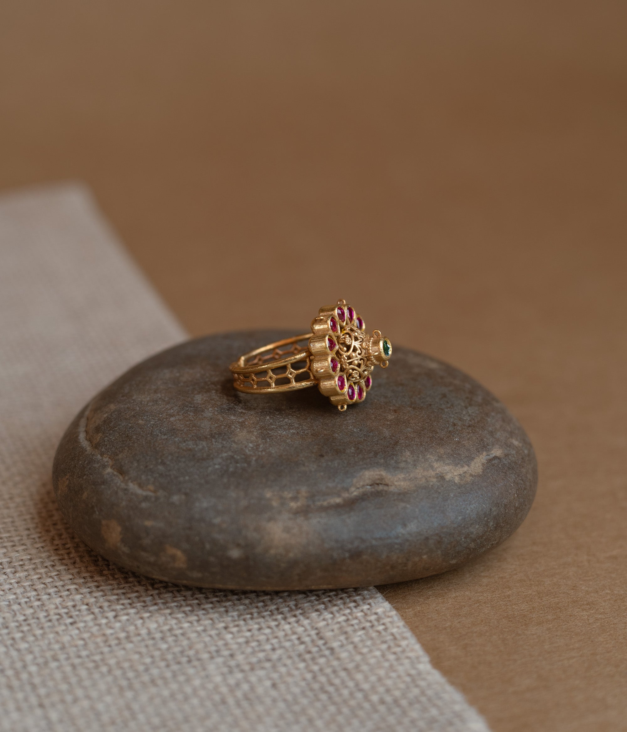 Temple ring with red Spinal and white Polki stones in traditional dual-tone design.