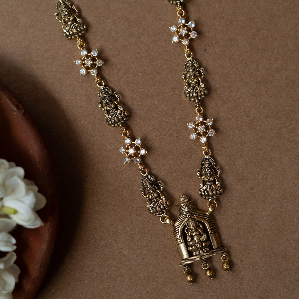 A 92.5 sterling silver Gauri Temple Pendant Necklace, featuring antique-finish Lakshmi motifs, floral crystal links, and a central temple pendant, invoking divine elegance for festive and traditional celebrations.