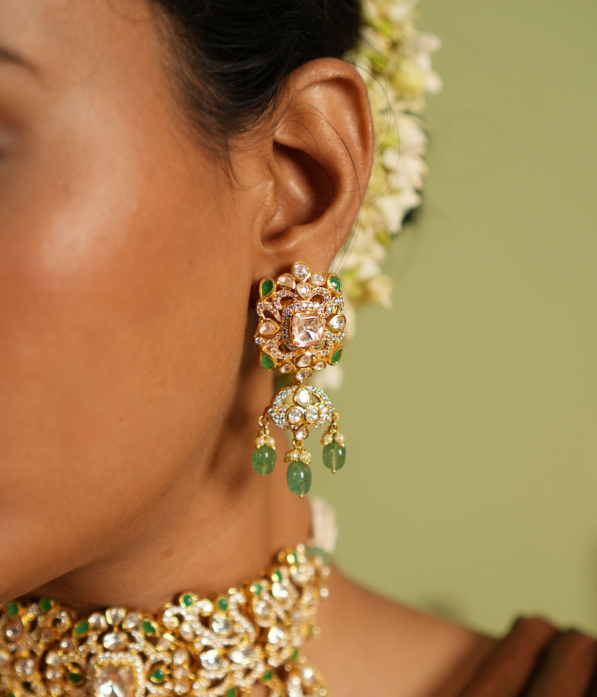 Graceful dangler earrings crafted in silver with a gold-plated finish, featuring intricate Polki stones, vibrant strawberry quartz, and sparkling CZ stones for a stunning and timeless design.