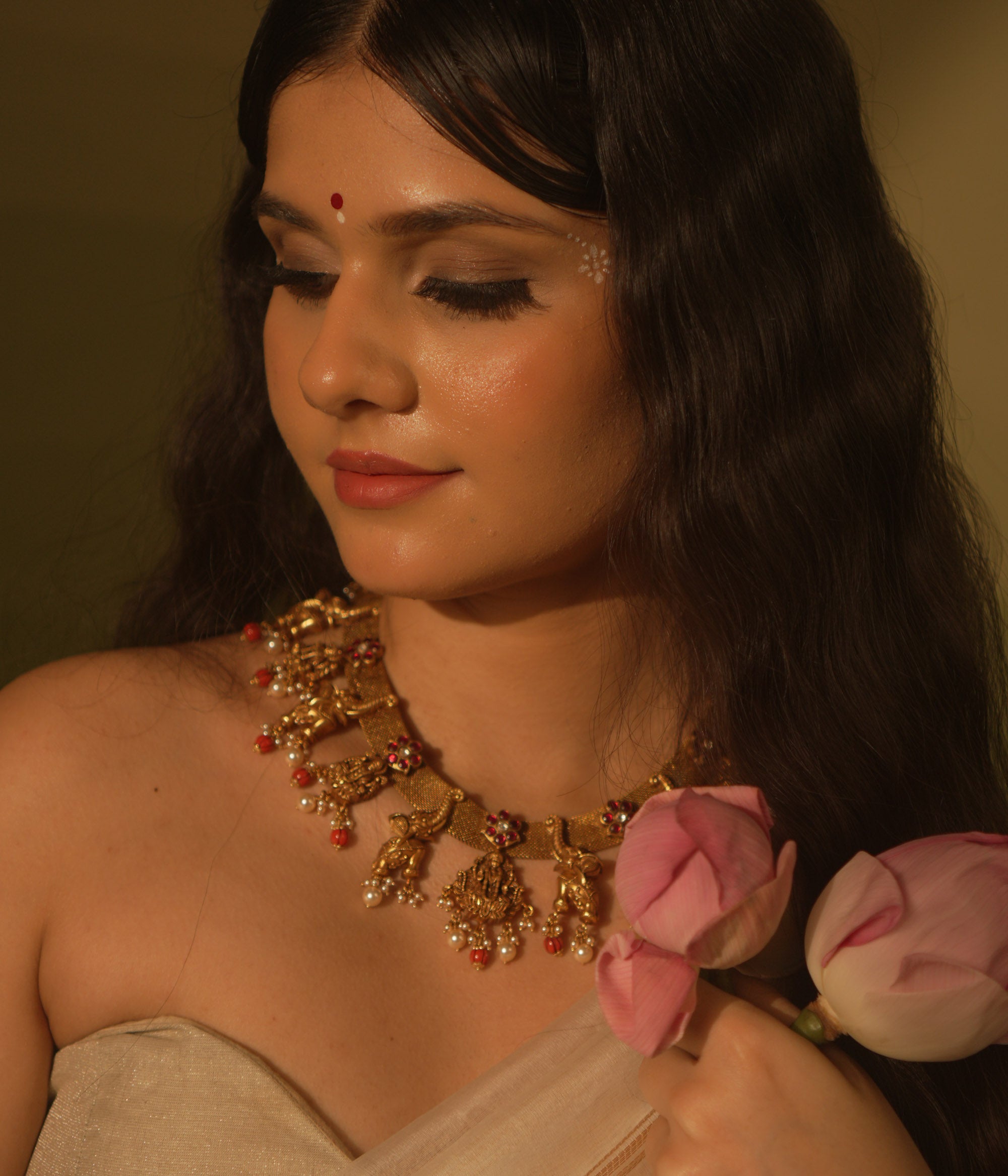 Temple collection Aamal Necklace featuring Goddess Lakshmi, elephant motifs, pink Kundan stones, pearls, and coral beads.