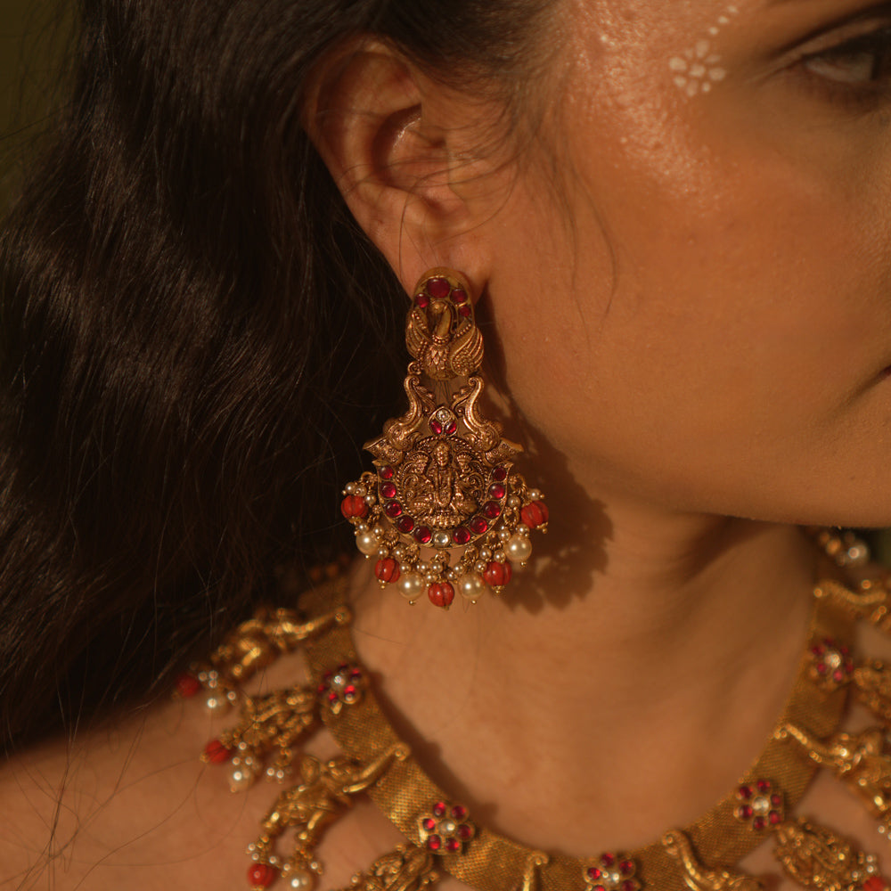 Temple collection Aamala Earrings with Goddess Lakshmi motif, elephants, pink Kundan stones, pearls, and coral beads.