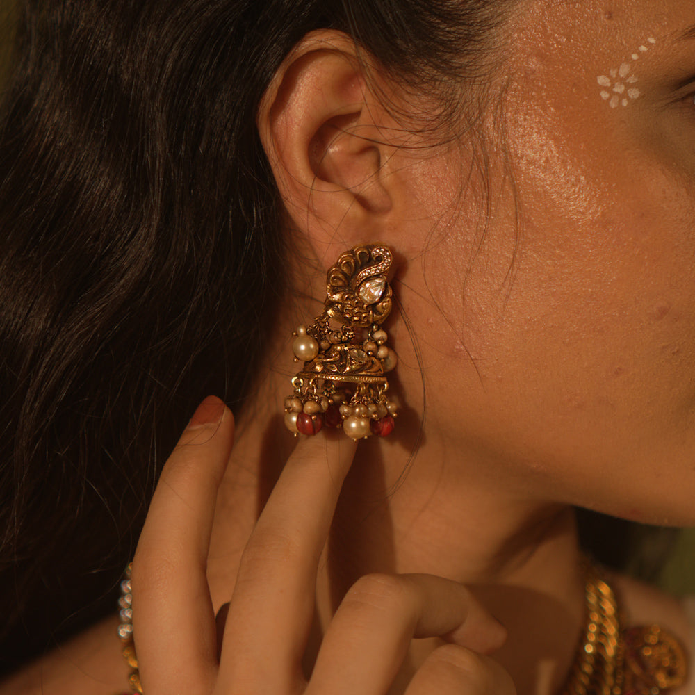 Temple collection Ujjaini Earrings with peacock motifs, coral stones, and Basra pearls, inspired by traditional Indian artistry.