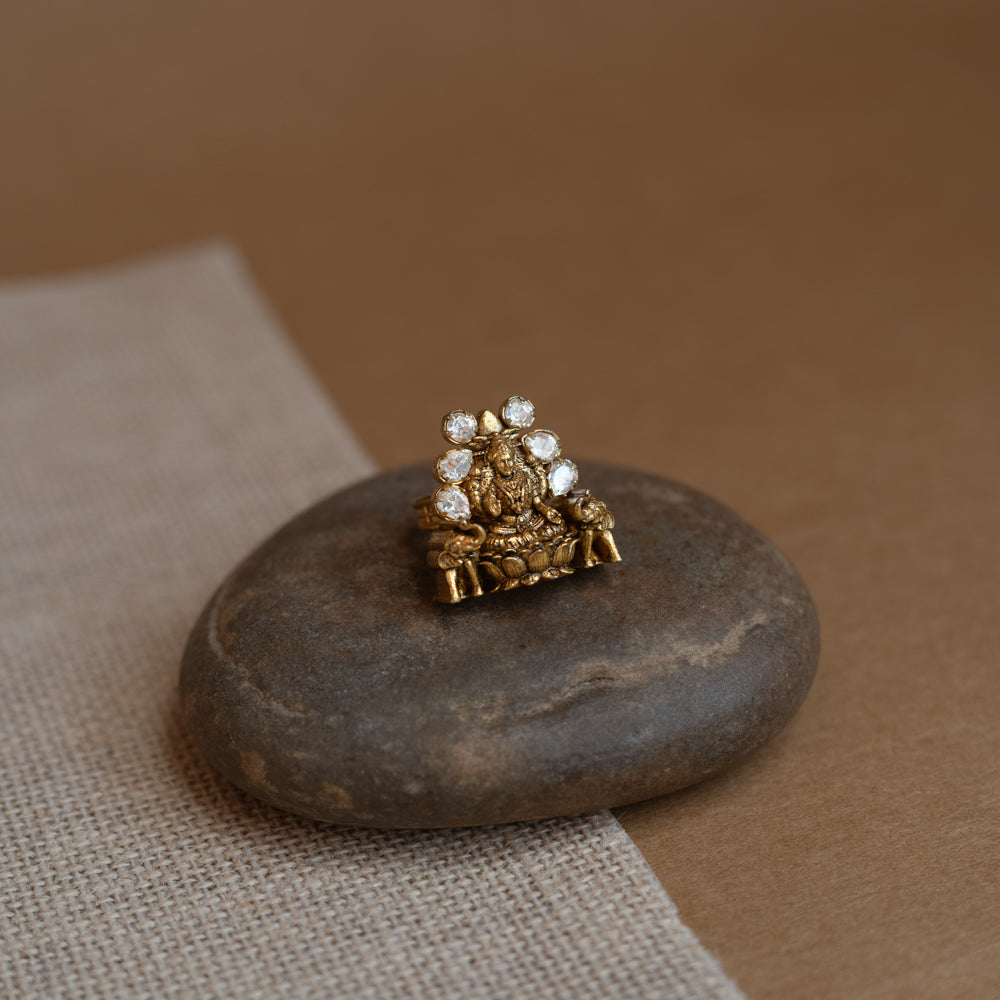 Temple ring with white Polki stone and intricate temple-inspired design for traditional occasions.
