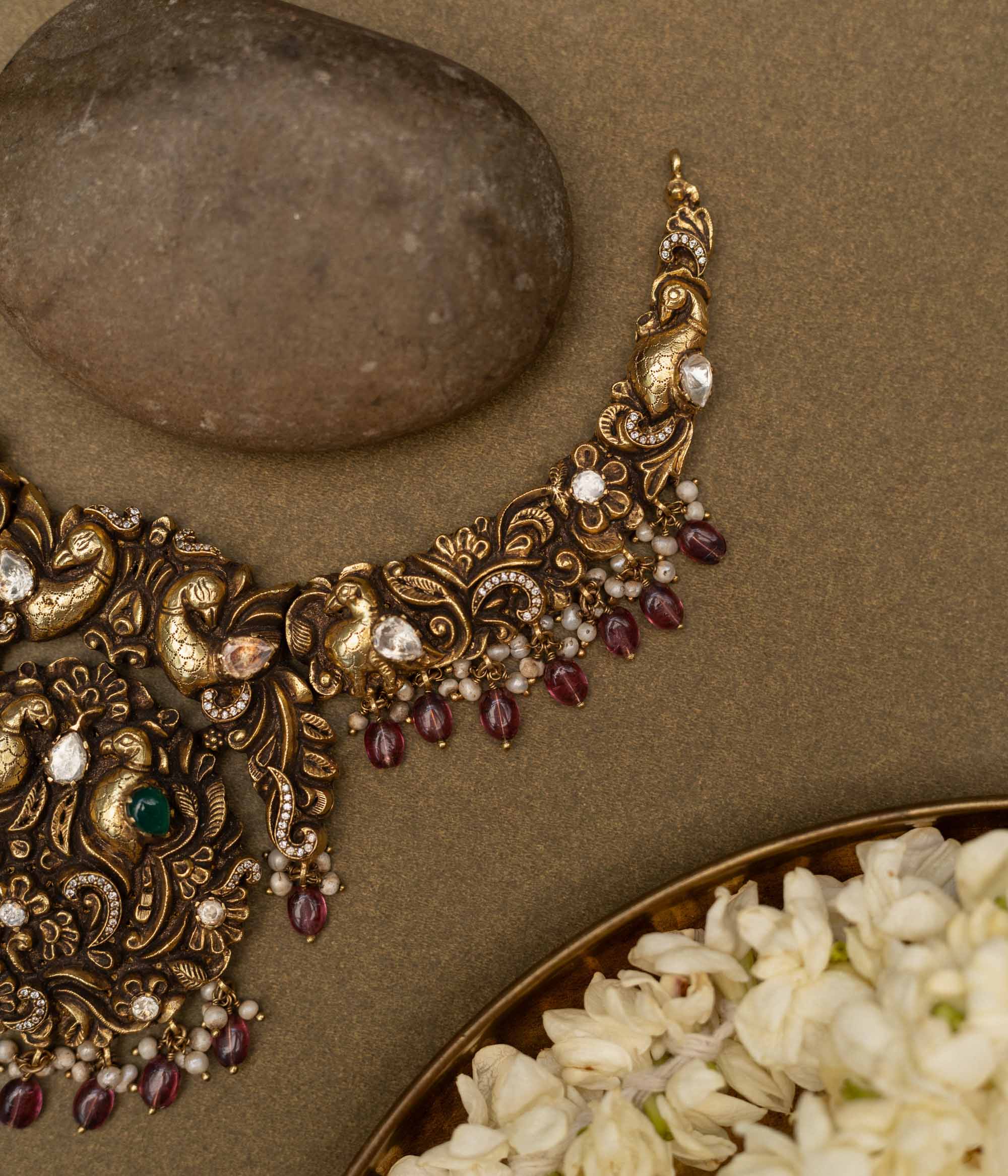 Antique gold-finished 92.5 sterling silver necklace with intricately handcrafted peacocks adorned with vibrant gemstones and pearl drops, embodying regal elegance and traditional opulence.