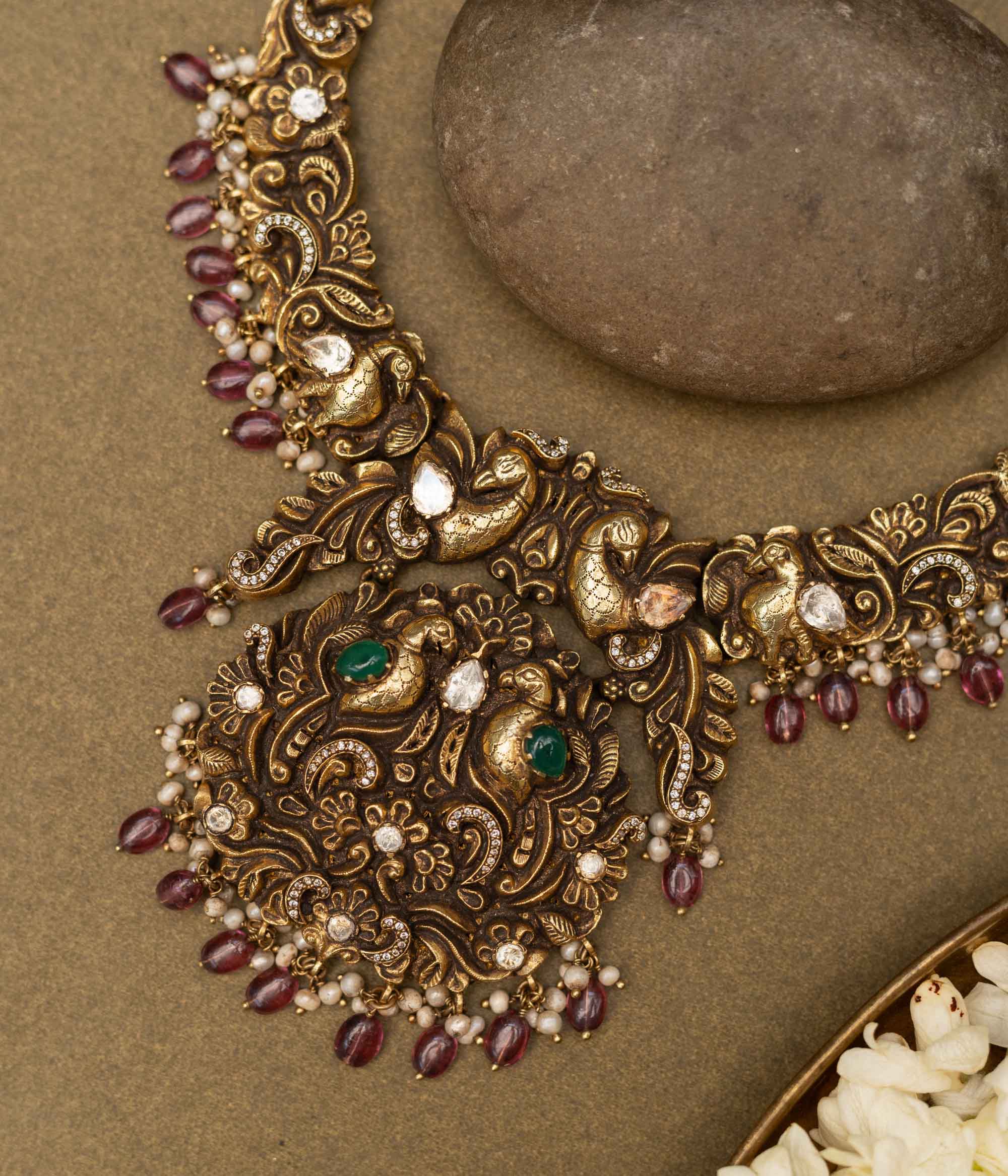 Antique gold-finished 92.5 sterling silver necklace with intricately handcrafted peacocks adorned with vibrant gemstones and pearl drops, embodying regal elegance and traditional opulence.