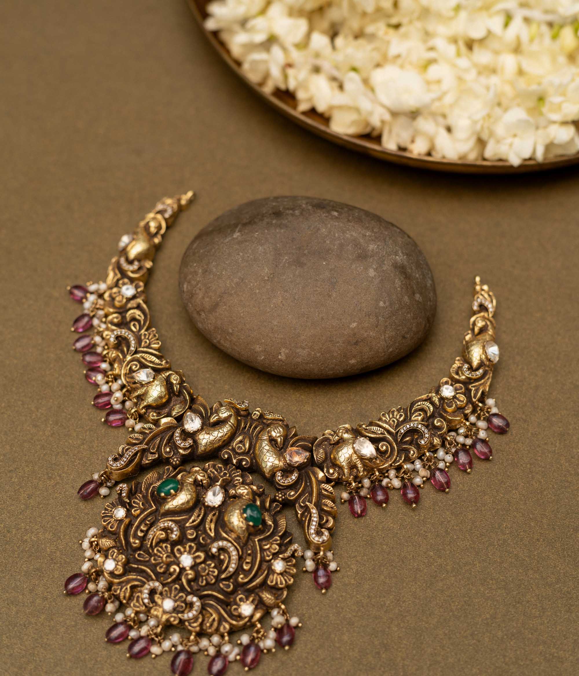 Antique gold-finished 92.5 sterling silver necklace with intricately handcrafted peacocks adorned with vibrant gemstones and pearl drops, embodying regal elegance and traditional opulence.