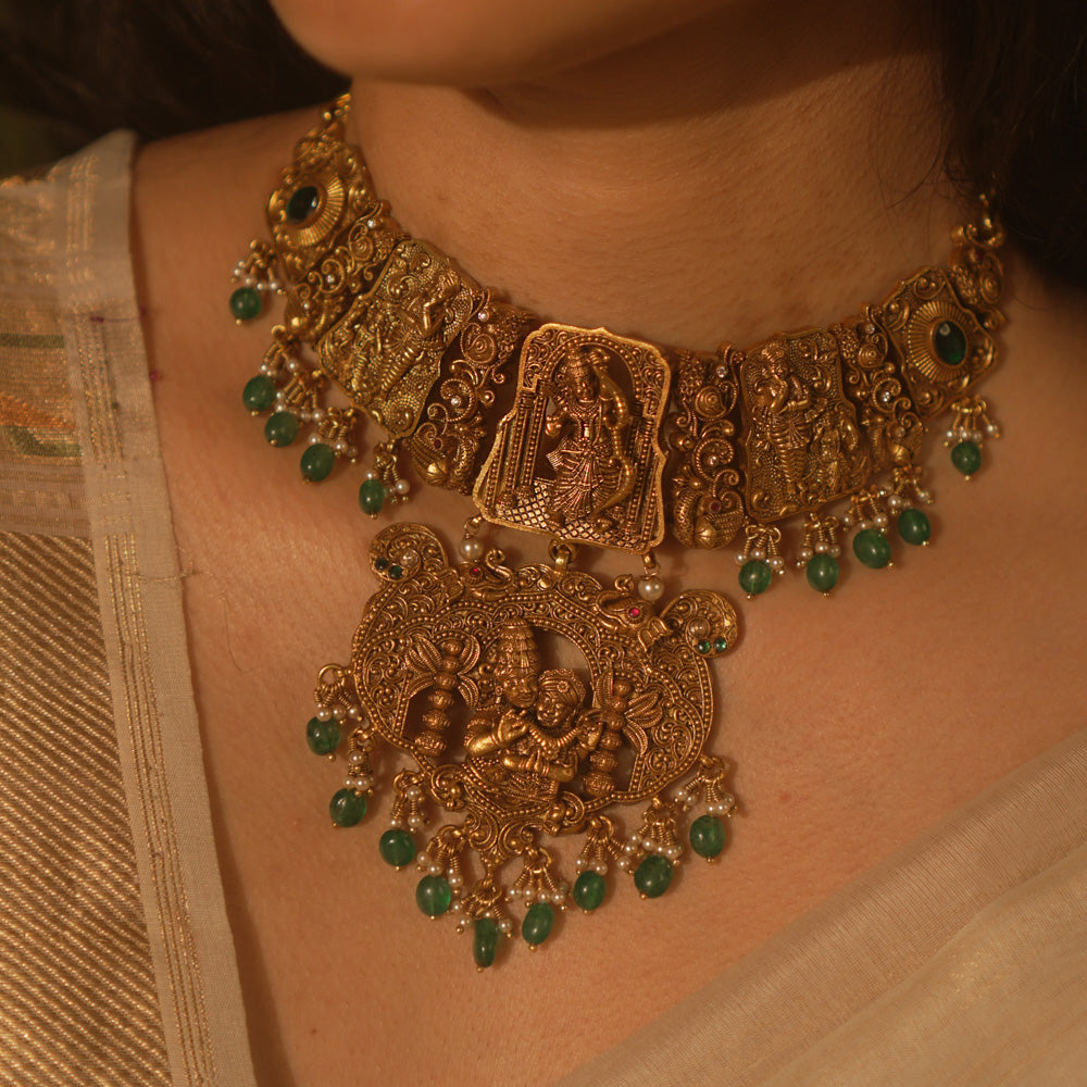 Temple collection Aadhavi Necklace inspired by Ramayana, adorned with green gemstones, Basra pearls, and intricate temple motifs.