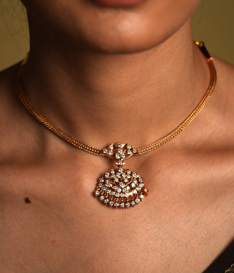 Crafted from high-quality 925 sterling silver and elegantly gold-plated, this choker features a traditional Chettinad pendant that embodies vintage sophistication. The gold plating gives the piece a luxurious glow, while the intricate details of the pendant reflect the rich heritage of Chettinad craftsmanship.