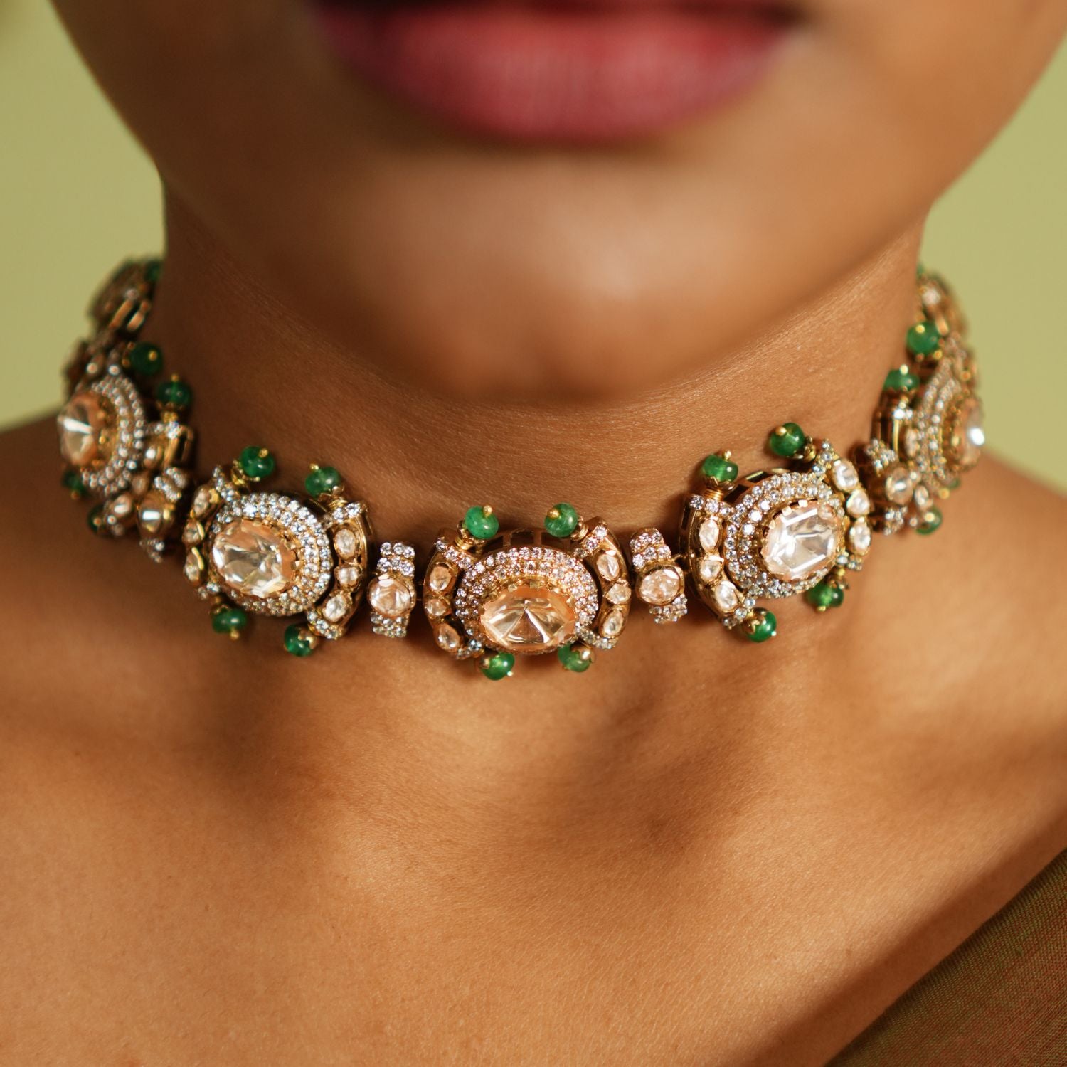 Graceful silver necklace with gold plating, embellished with radiant Polki stones and dazzling cubic zirconia (CZ) stones. This exquisite piece showcases a blend of traditional elegance and contemporary style, making it a perfect accessory for special occasions.