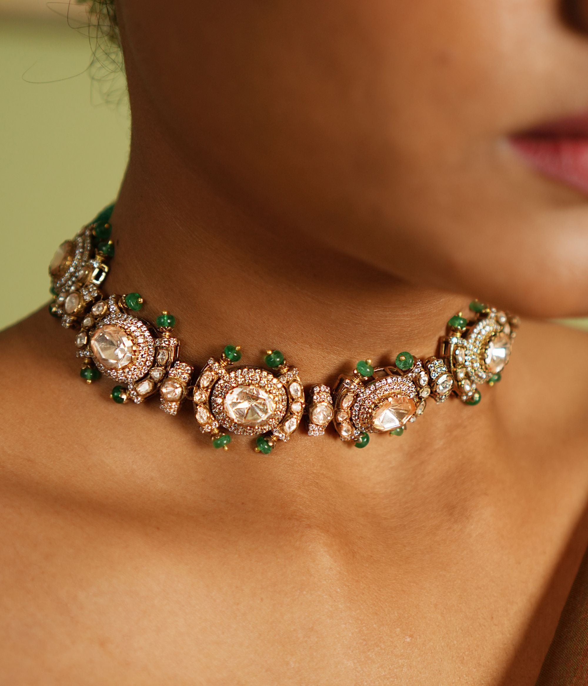 Graceful silver necklace with gold plating, embellished with radiant Polki stones and dazzling cubic zirconia (CZ) stones. This exquisite piece showcases a blend of traditional elegance and contemporary style, making it a perfect accessory for special occasions.