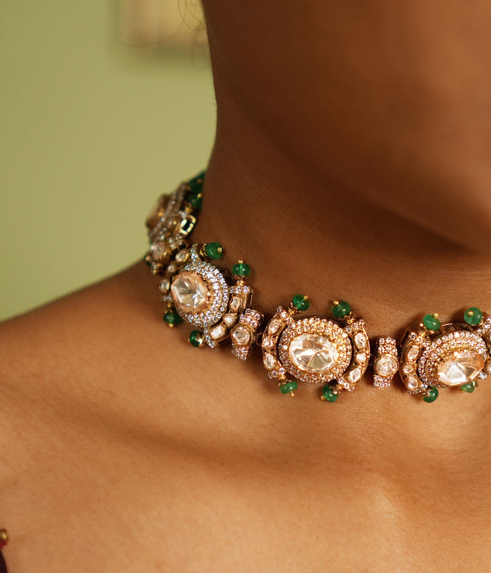 Graceful silver necklace with gold plating, embellished with radiant Polki stones and dazzling cubic zirconia (CZ) stones. This exquisite piece showcases a blend of traditional elegance and contemporary style, making it a perfect accessory for special occasions.