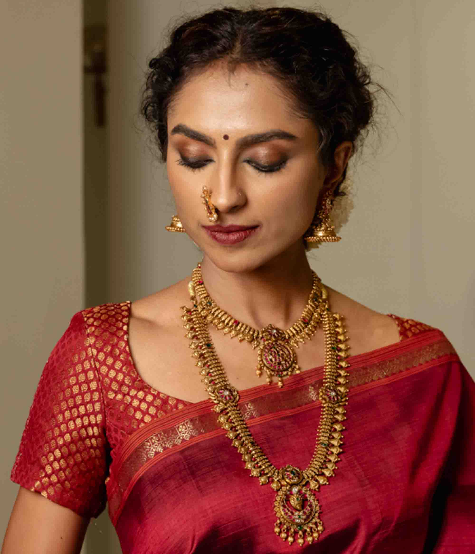 Driti Nakas long silver necklace with red and green Kundan stones