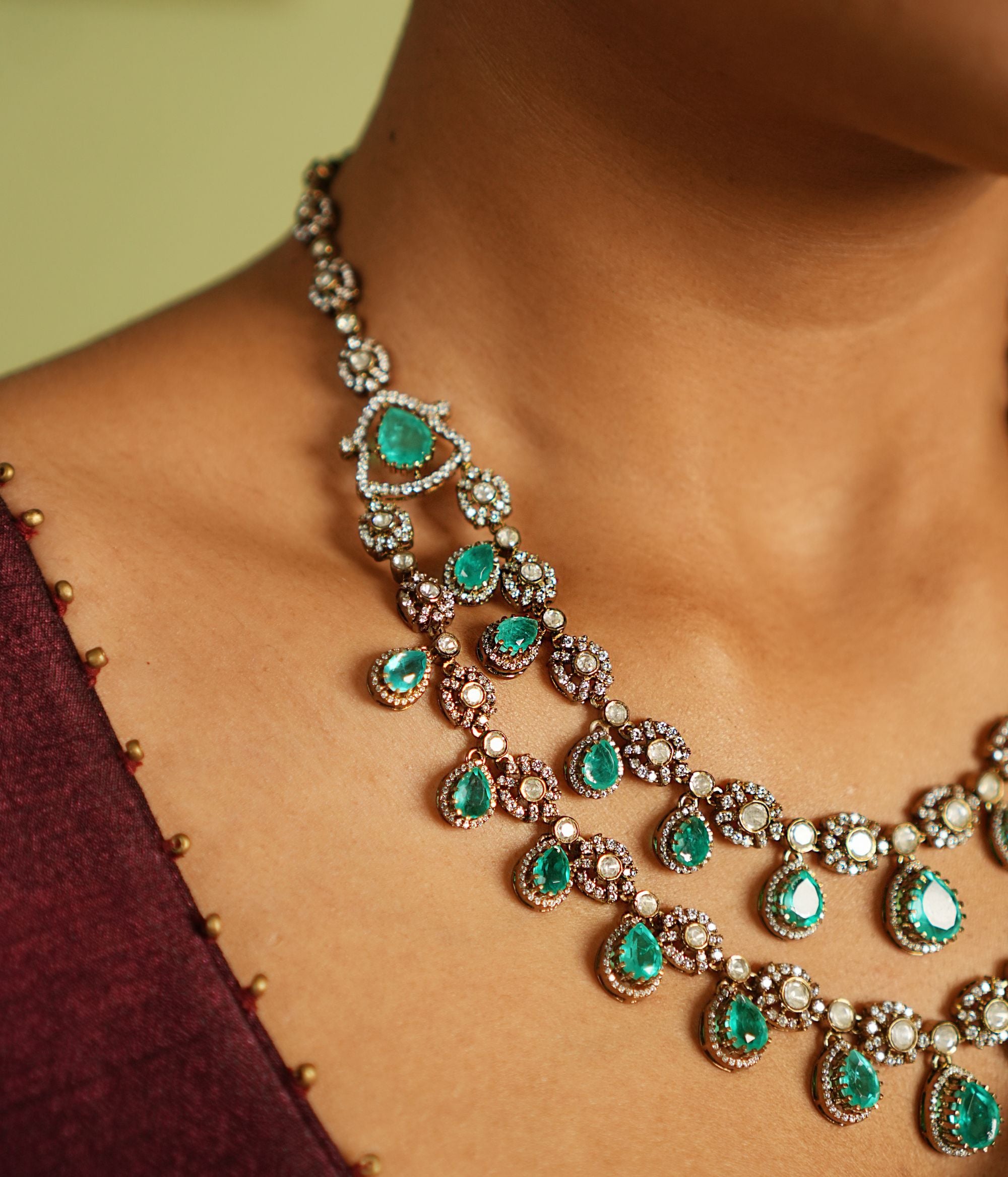 Exquisite two-layer gold-plated silver necklace adorned with moissanite Polki stones, CZ stones, and vibrant green gemstones, showcasing a timeless and sophisticated design perfect for any occasion.