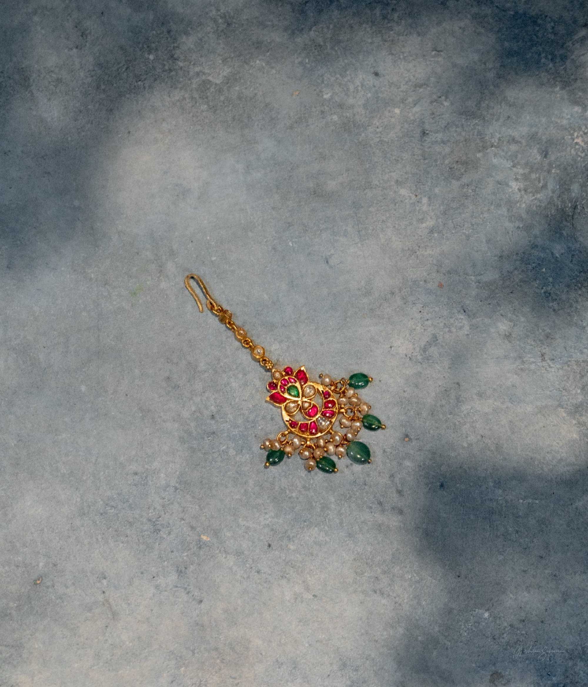 Elegant red green white Kundan Tikka with lustrous pearls