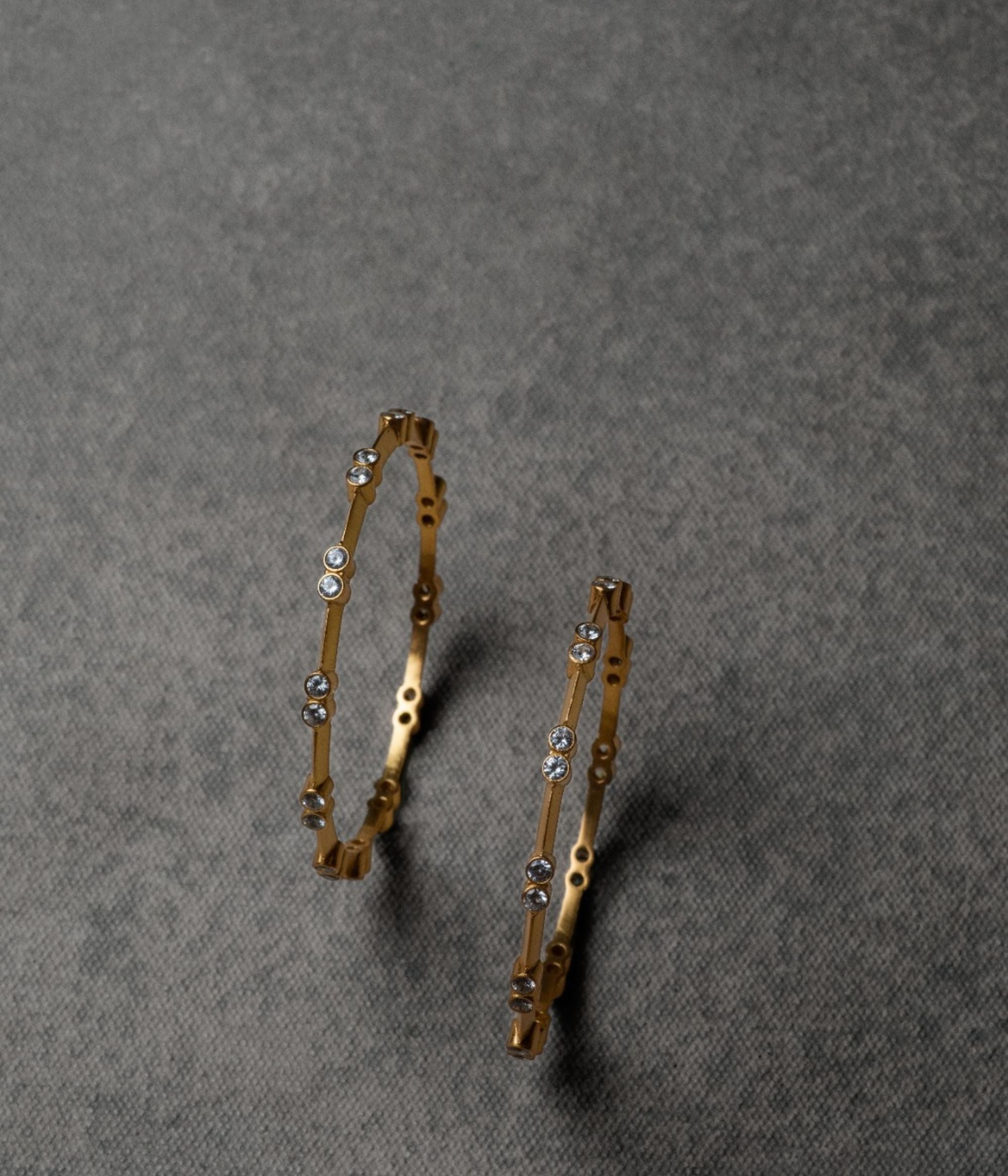 A sleek sterling silver bangle adorned with CZ stones, exuding understated elegance and sophistication—an ideal accessory to elevate any outfit with a touch of sparkle.