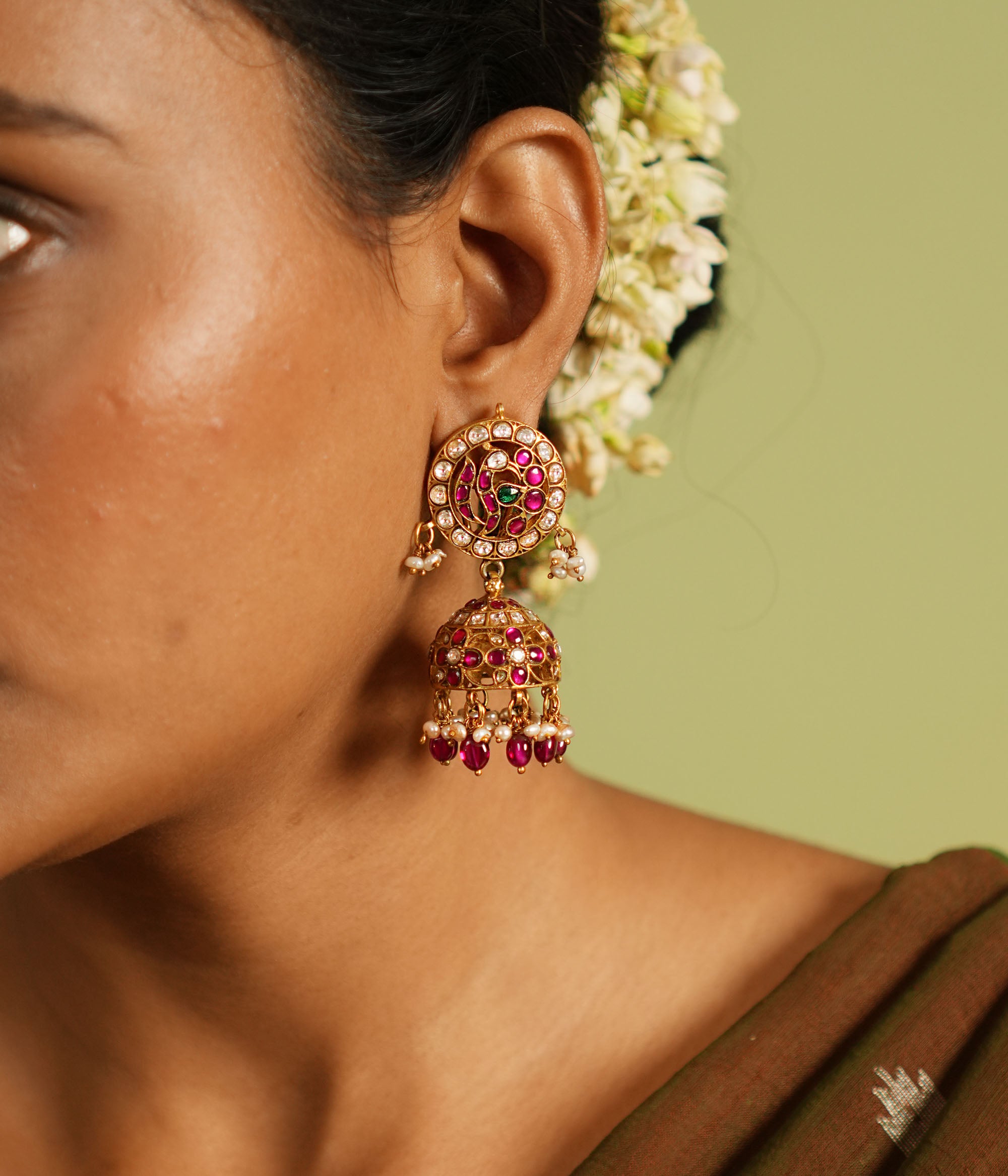 White, red, and green Kundan stone jhumkas with pearl drops
