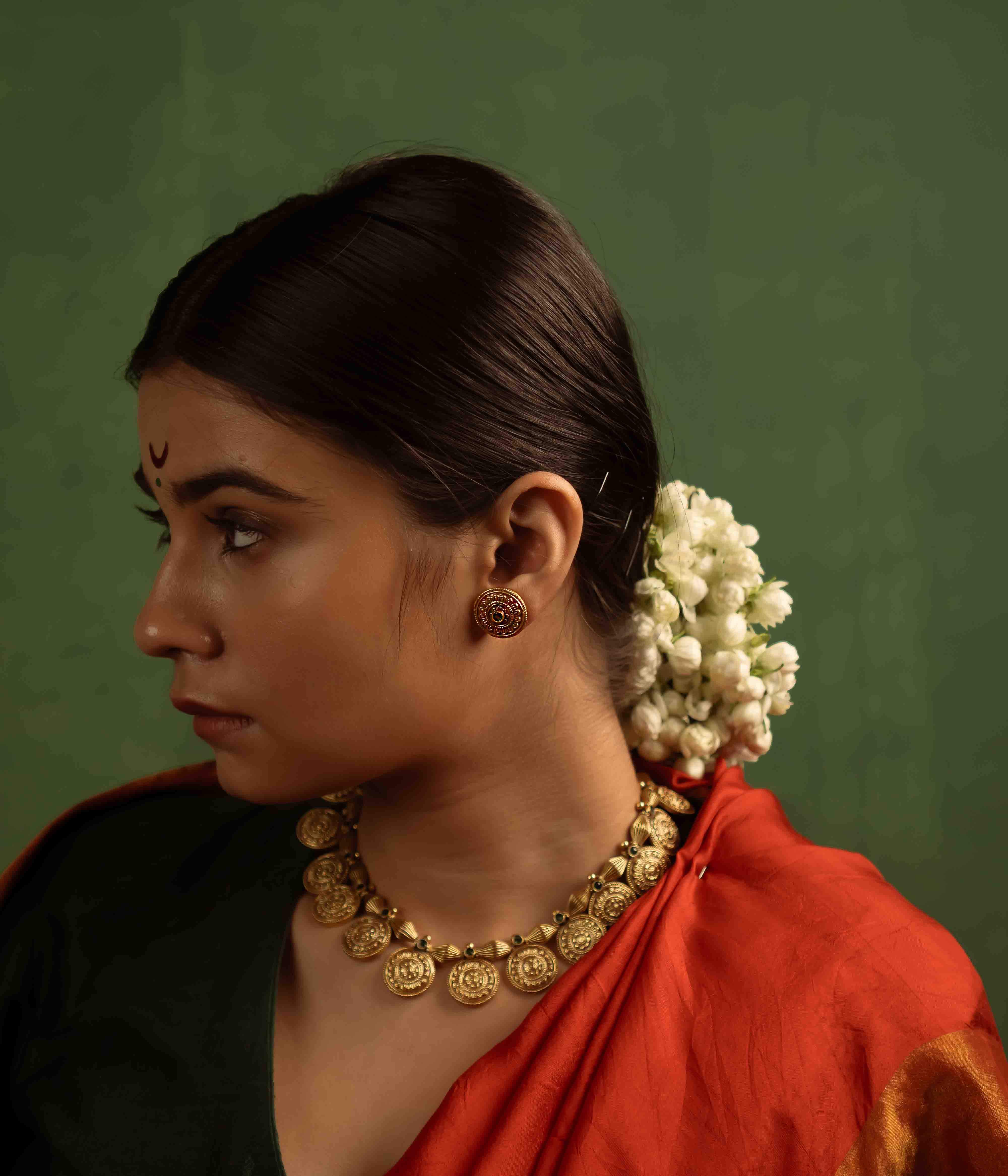 Handcrafted green stone gold plated silver earrings in Chennai