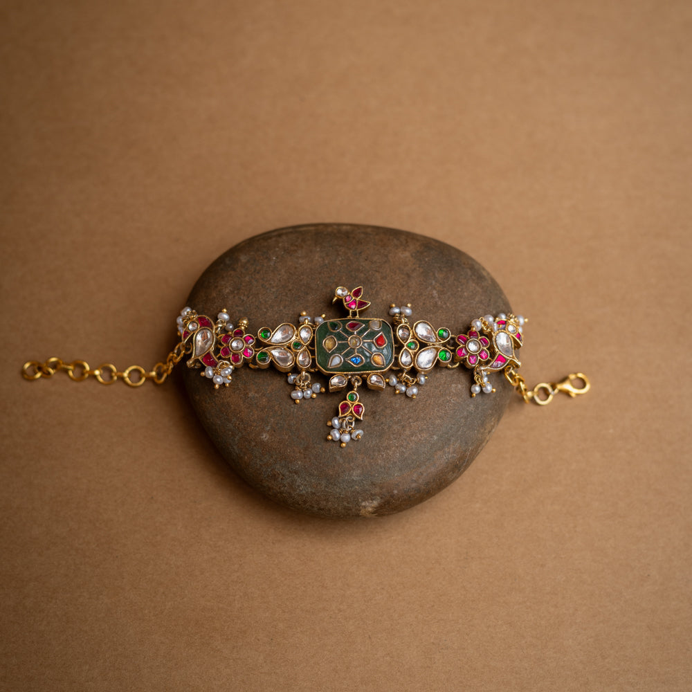 Multicolour stone and pearl-studded Hue Collection bracelet with rectangular centre and floral Kundan motifs.
