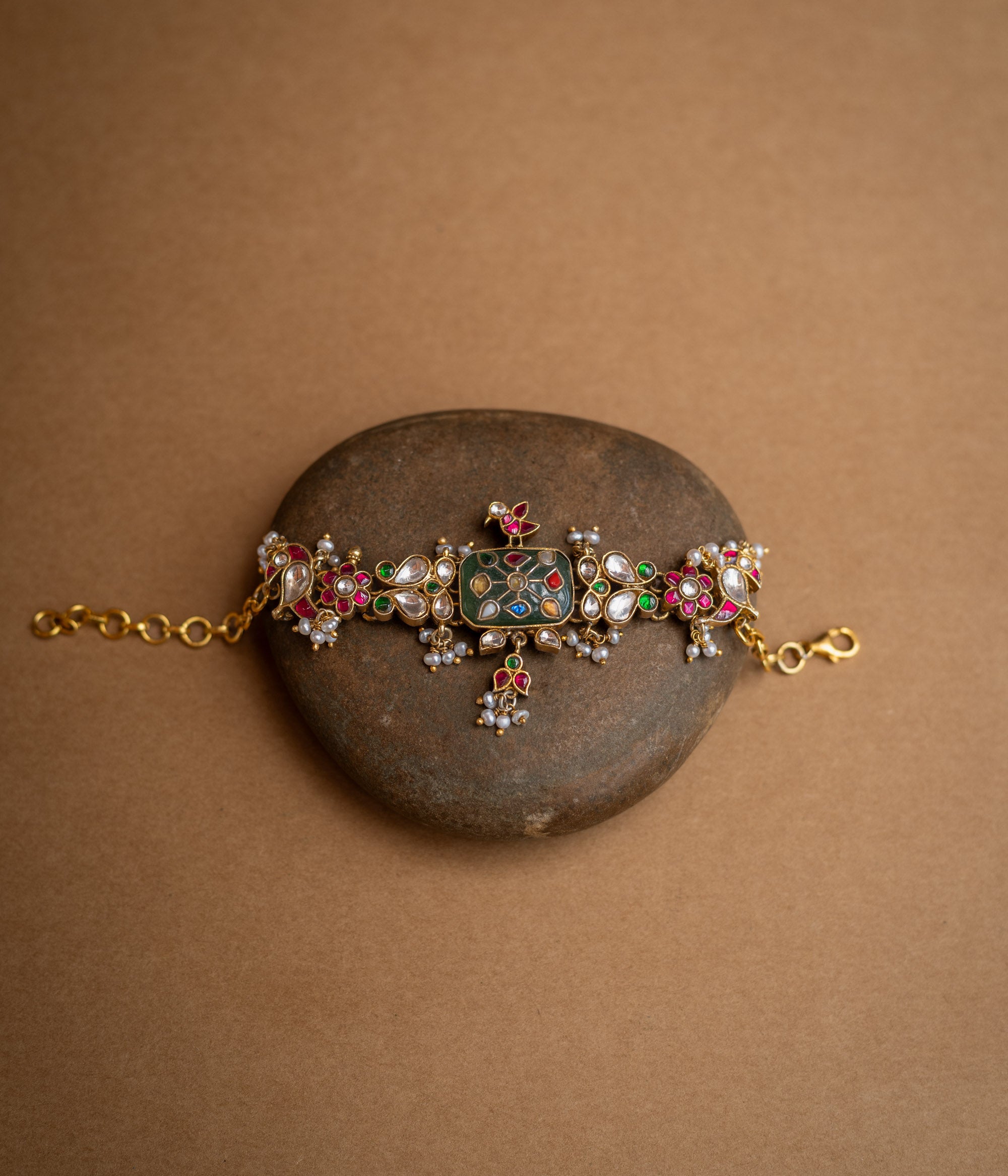 Multicolour stone and pearl-studded Hue Collection bracelet with rectangular centre and floral Kundan motifs.